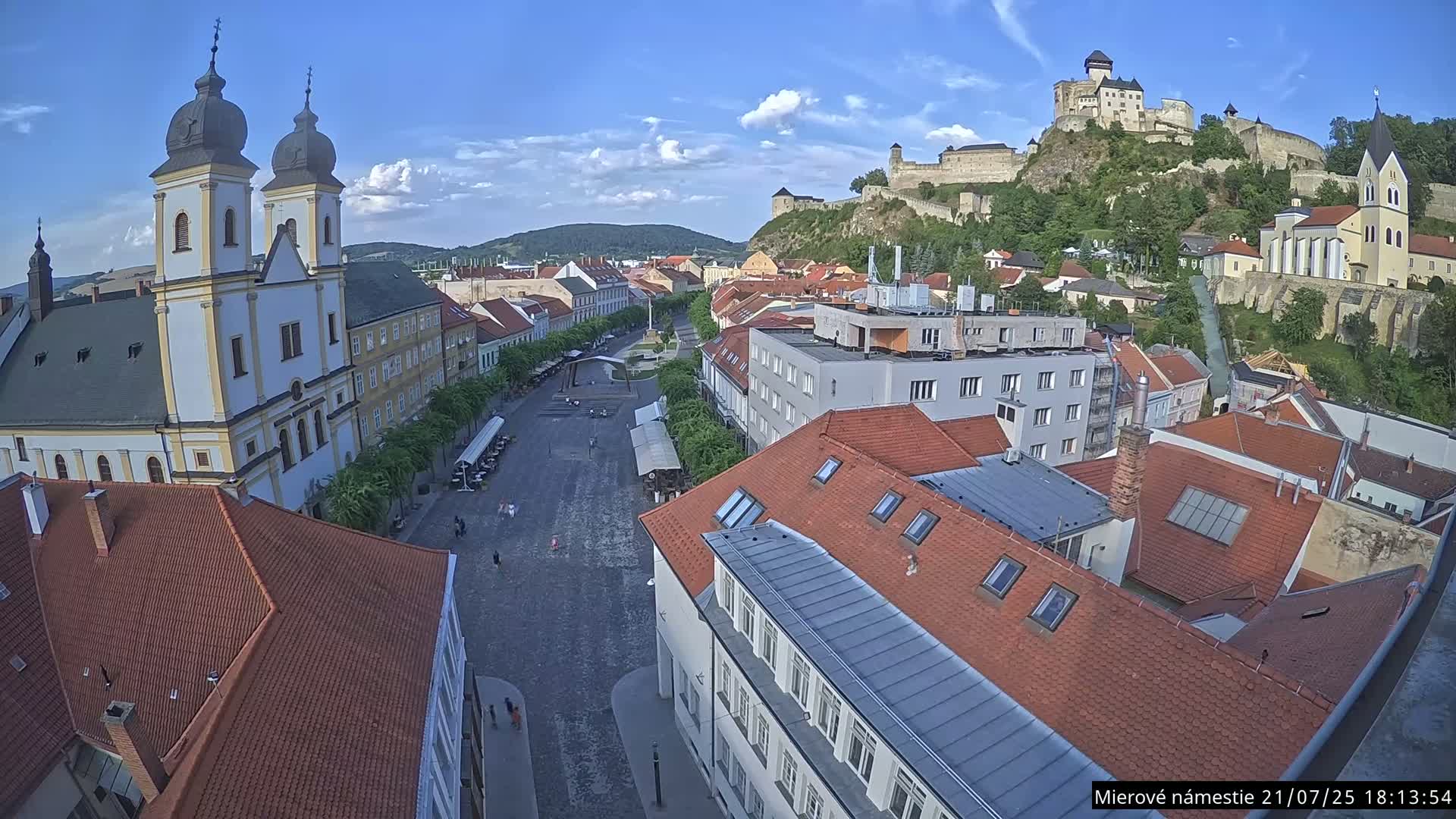 Trenčín, Piaristický kostol sv. Františka Xaverského Church & Trenciansky Hrad (Ttencin Castle) at Mierové námestie Square East View Live Cam - Trencin, Okres Trencin, Slovakia 
