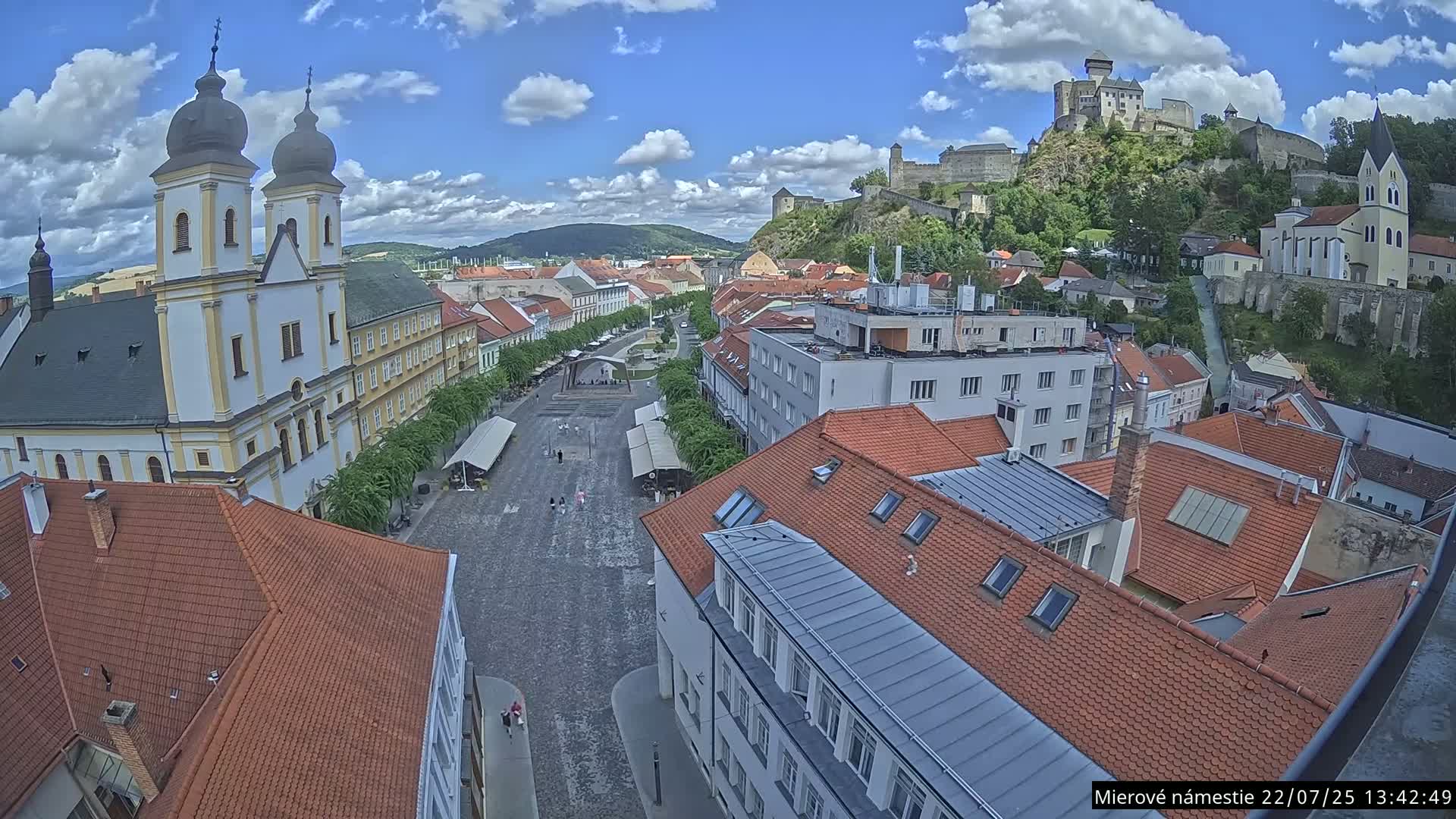 Trenčín, Piaristický kostol sv. Františka Xaverského Church & Trenciansky Hrad (Ttencin Castle) at Mierové námestie Square East View Live Cam - Trencin, Okres Trencin, Slovakia 