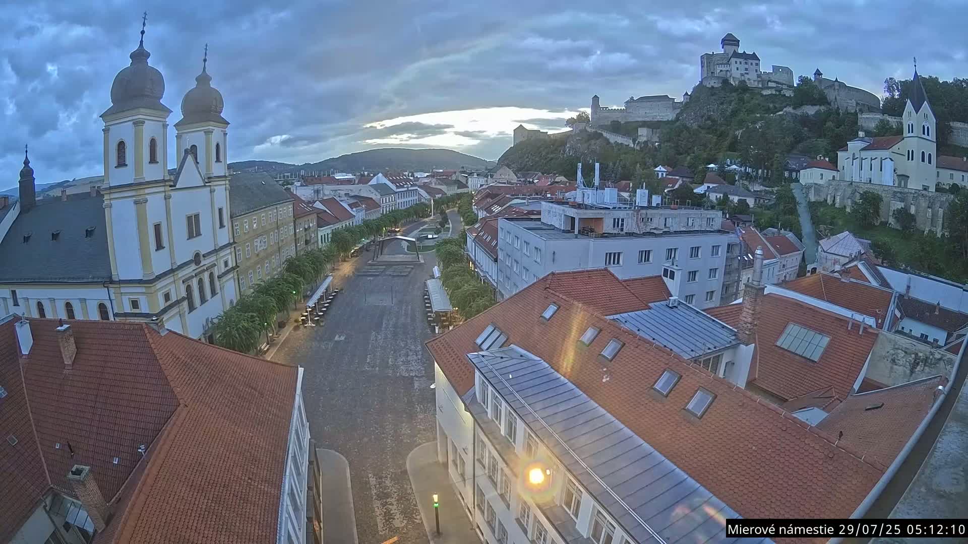 Trenčín, Piaristický kostol sv. Františka Xaverského Church & Trenciansky Hrad (Ttencin Castle) at Mierové námestie Square East View Live Cam - Trencin, Okres Trencin, Slovakia 