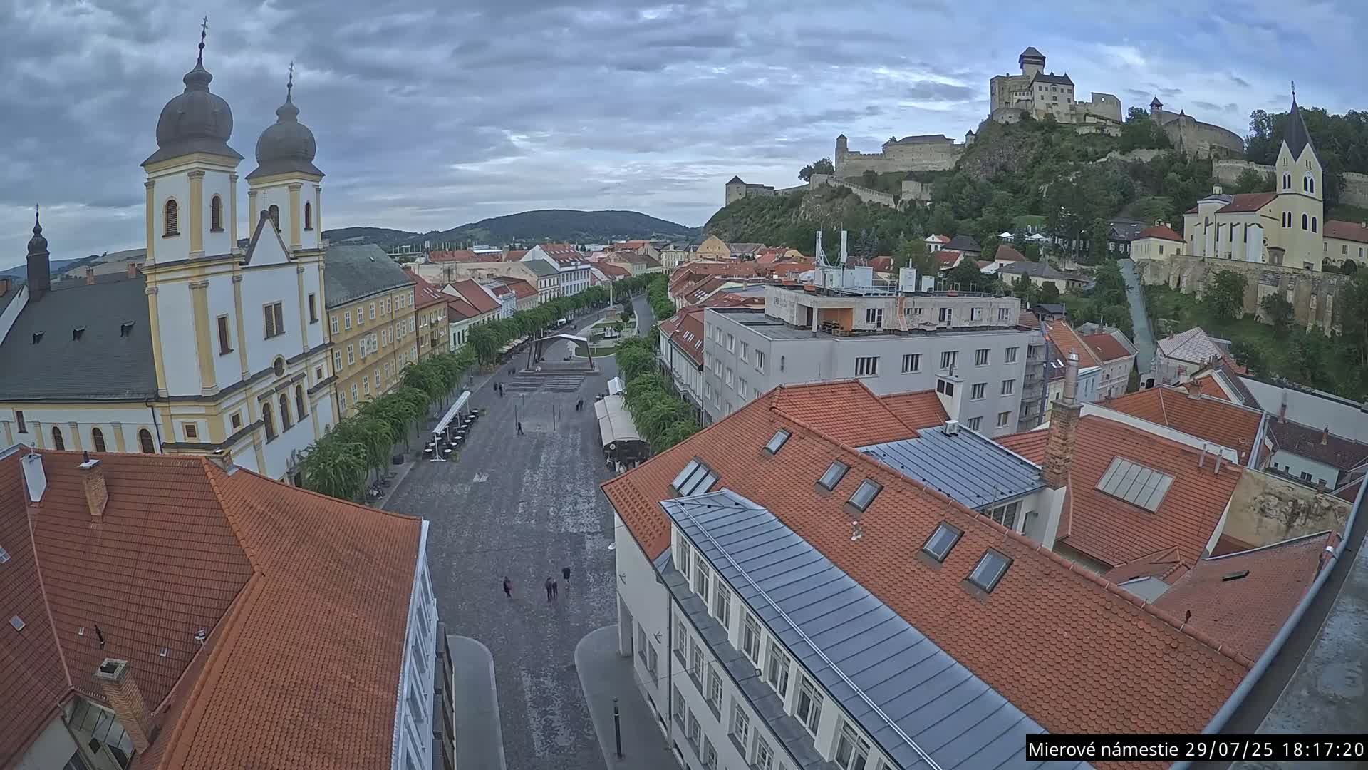Trenčín, Piaristický kostol sv. Františka Xaverského Church & Trenciansky Hrad (Ttencin Castle) at Mierové námestie Square East View Live Cam - Trencin, Okres Trencin, Slovakia 