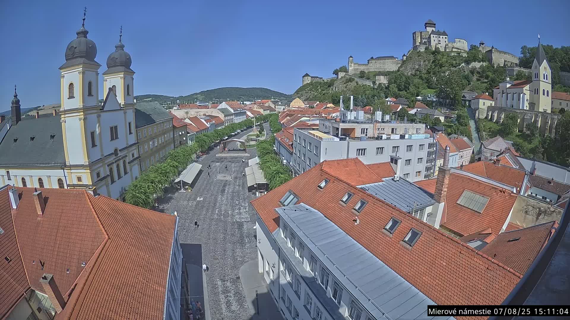 Trenčín, Piaristický kostol sv. Františka Xaverského Church & Trenciansky Hrad (Ttencin Castle) at Mierové námestie Square East View Live Cam - Trencin, Okres Trencin, Slovakia 