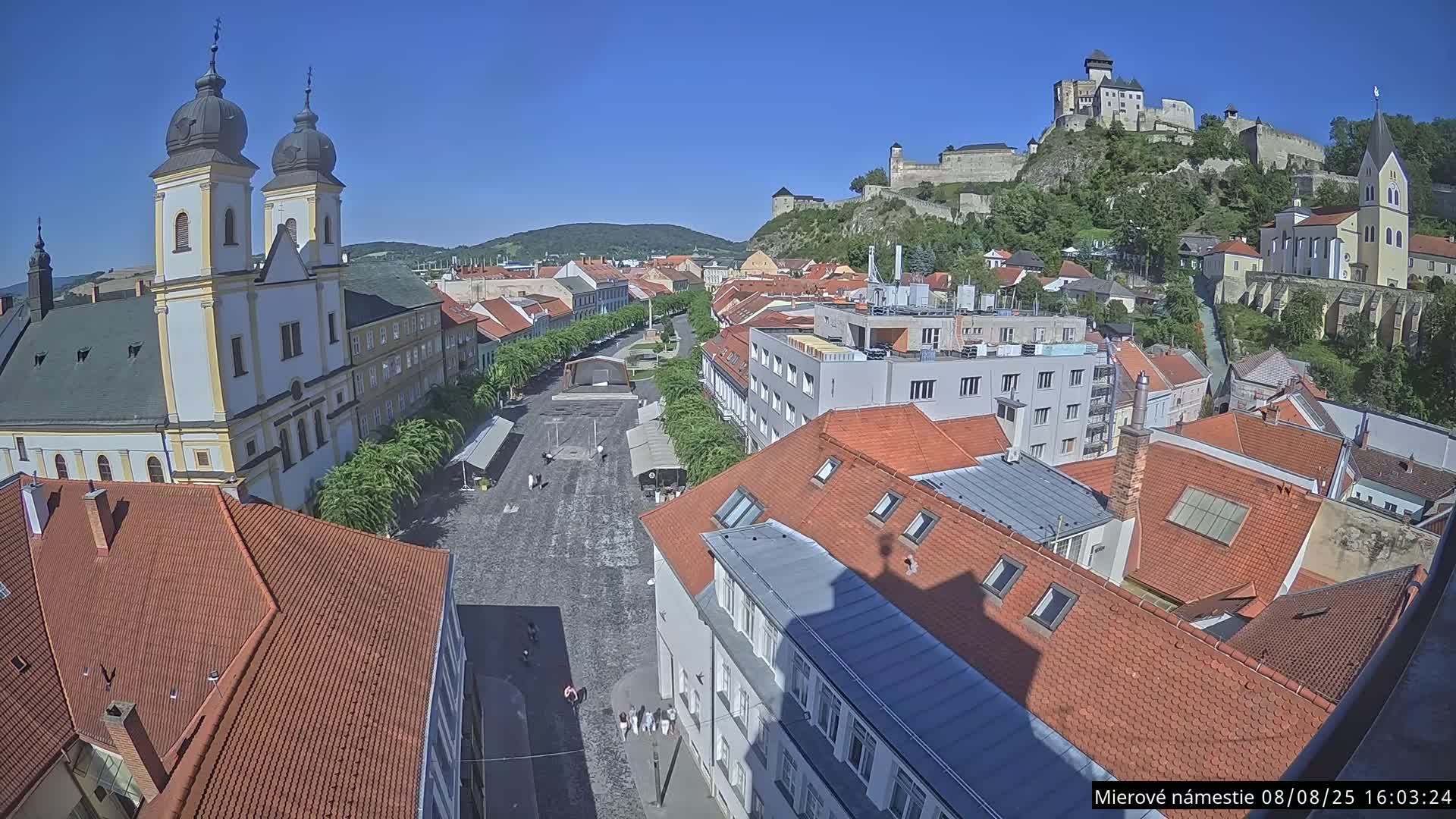 Trenčín, Piaristický kostol sv. Františka Xaverského Church & Trenciansky Hrad (Ttencin Castle) at Mierové námestie Square East View Live Cam - Trencin, Okres Trencin, Slovakia 