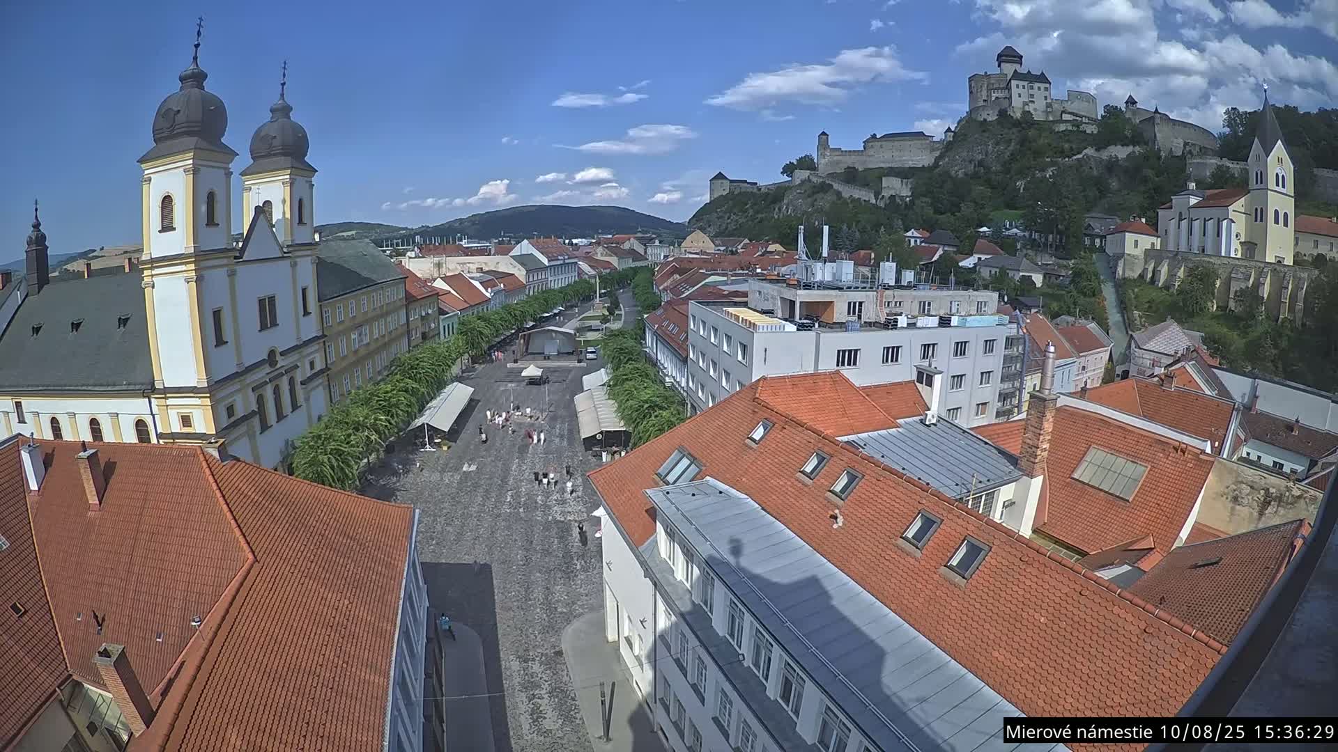 Trenčín, Piaristický kostol sv. Františka Xaverského Church & Trenciansky Hrad (Ttencin Castle) at Mierové námestie Square East View Live Cam - Trencin, Okres Trencin, Slovakia 