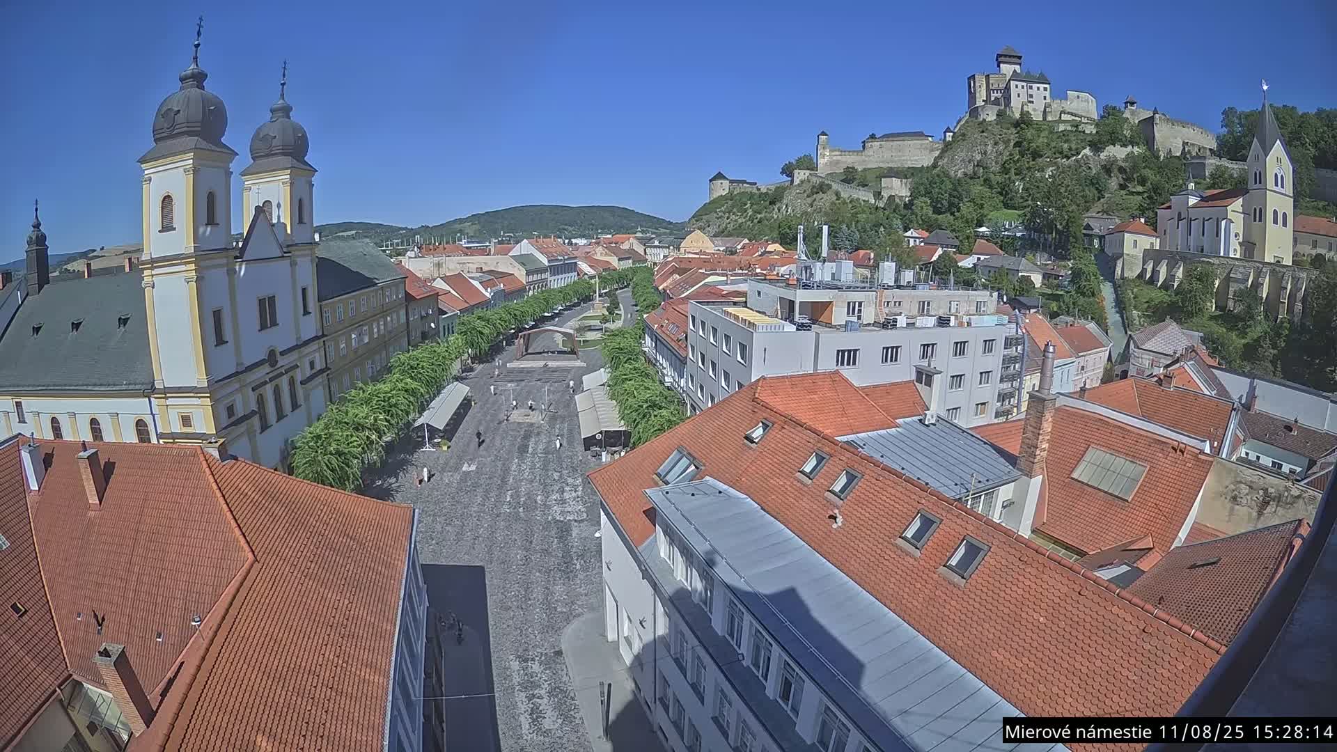 Trenčín, Piaristický kostol sv. Františka Xaverského Church & Trenciansky Hrad (Ttencin Castle) at Mierové námestie Square East View Live Cam - Trencin, Okres Trencin, Slovakia 