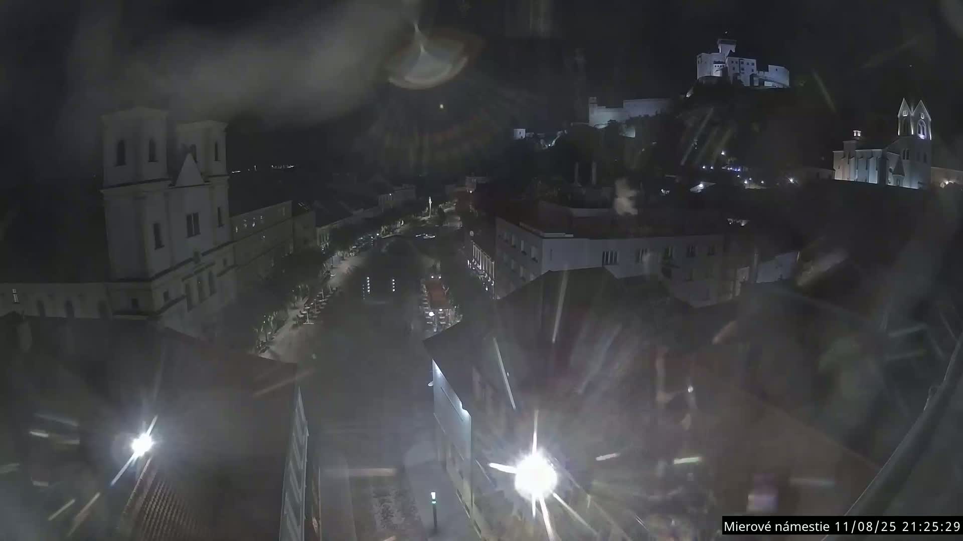 Trenčín, Piaristický kostol sv. Františka Xaverského Church & Trenciansky Hrad (Ttencin Castle) at Mierové námestie Square East View Live Cam - Trencin, Okres Trencin, Slovakia 
