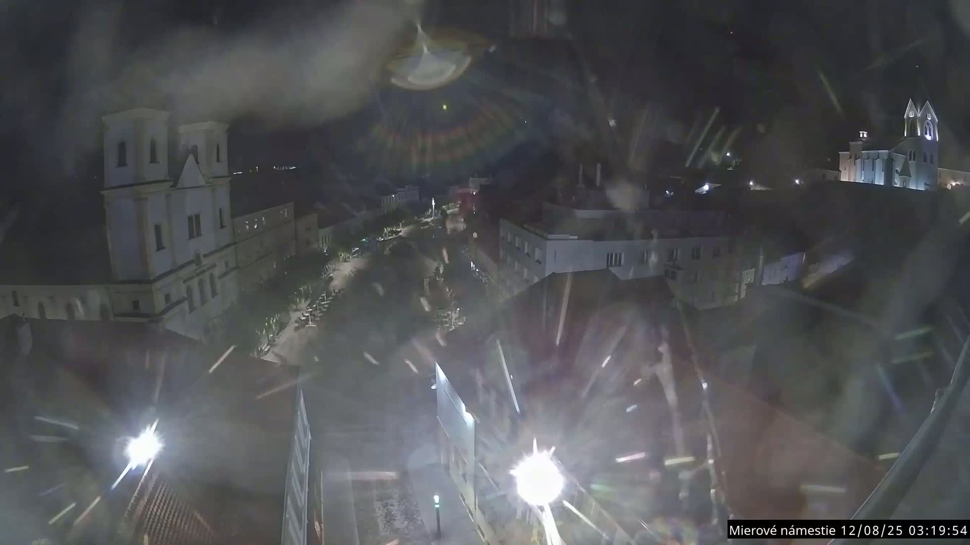 Trenčín, Piaristický kostol sv. Františka Xaverského Church & Trenciansky Hrad (Ttencin Castle) at Mierové námestie Square East View Live Cam - Trencin, Okres Trencin, Slovakia 