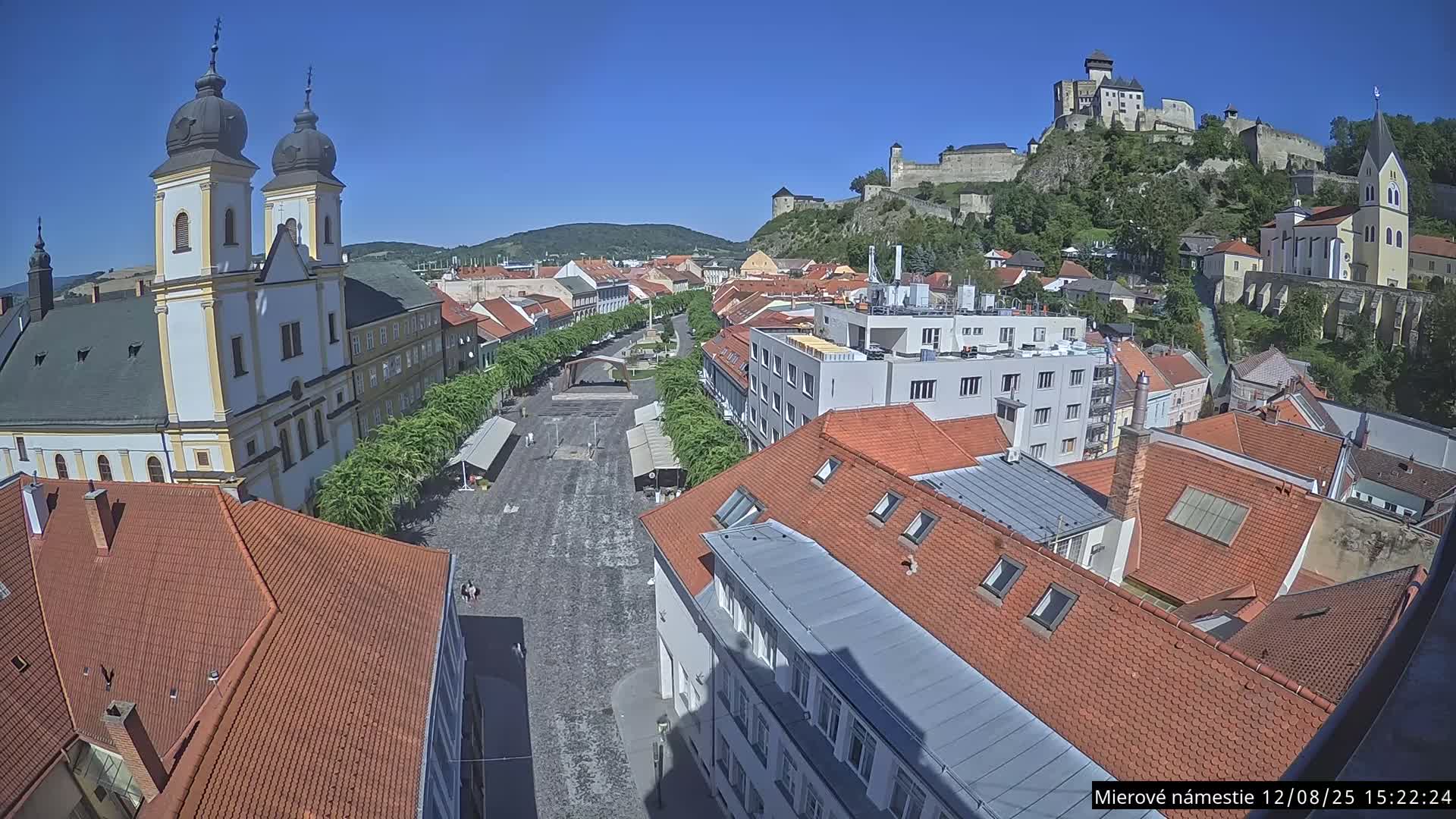 Trenčín, Piaristický kostol sv. Františka Xaverského Church & Trenciansky Hrad (Ttencin Castle) at Mierové námestie Square East View Live Cam - Trencin, Okres Trencin, Slovakia 