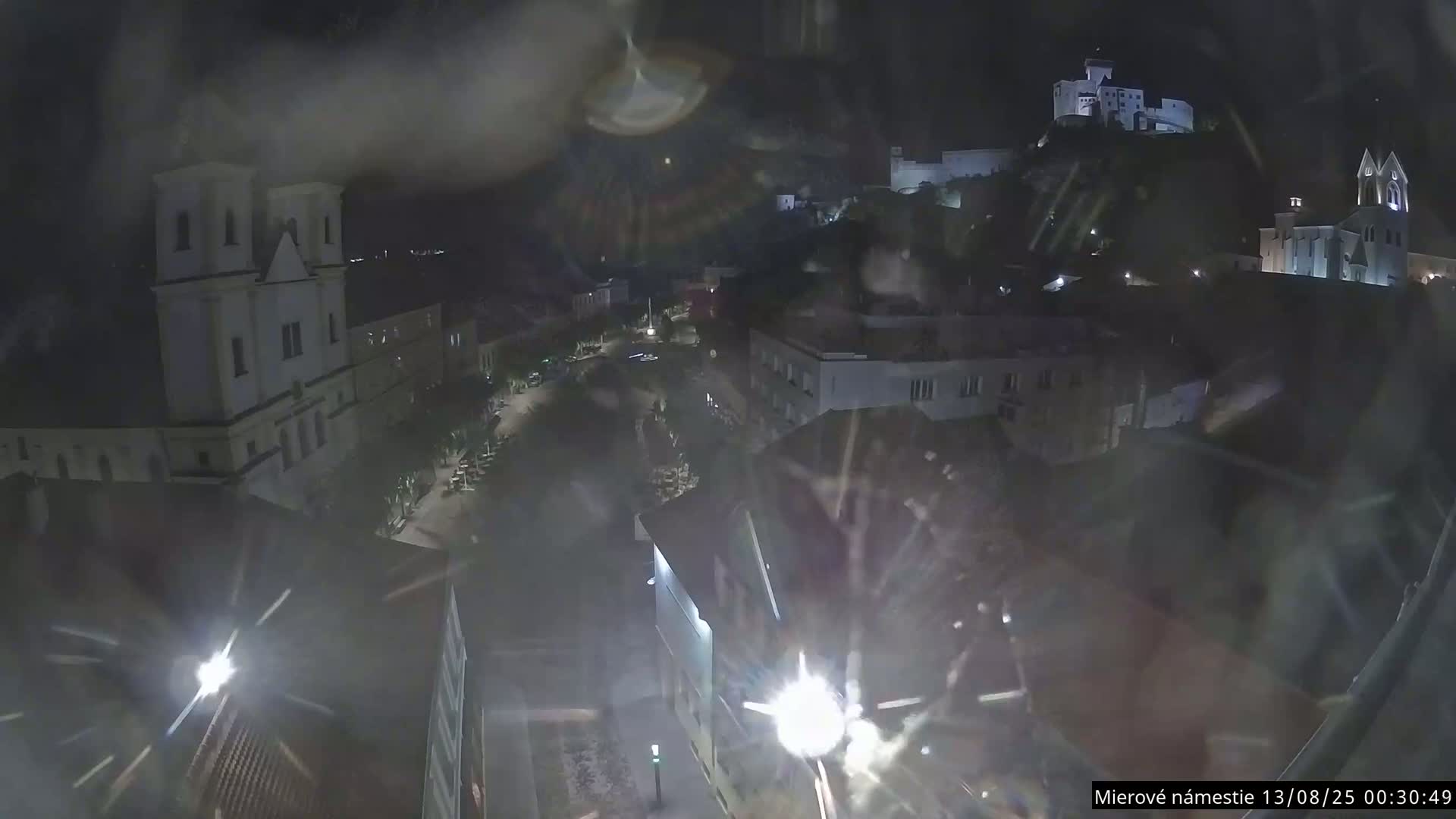 Trenčín, Piaristický kostol sv. Františka Xaverského Church & Trenciansky Hrad (Ttencin Castle) at Mierové námestie Square East View Live Cam - Trencin, Okres Trencin, Slovakia 