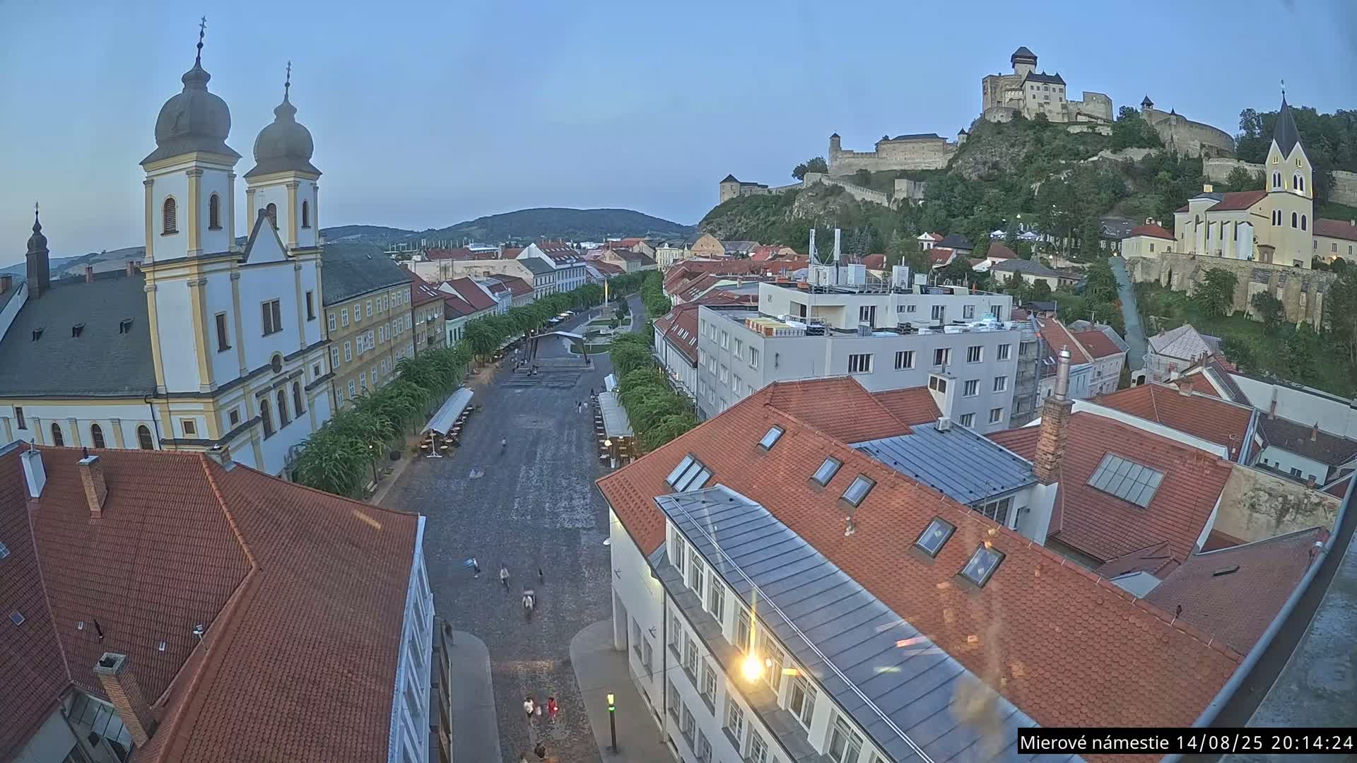 Trenčín, Piaristický kostol sv. Františka Xaverského Church & Trenciansky Hrad (Ttencin Castle) at Mierové námestie Square East View Live Cam - Trencin, Okres Trencin, Slovakia 