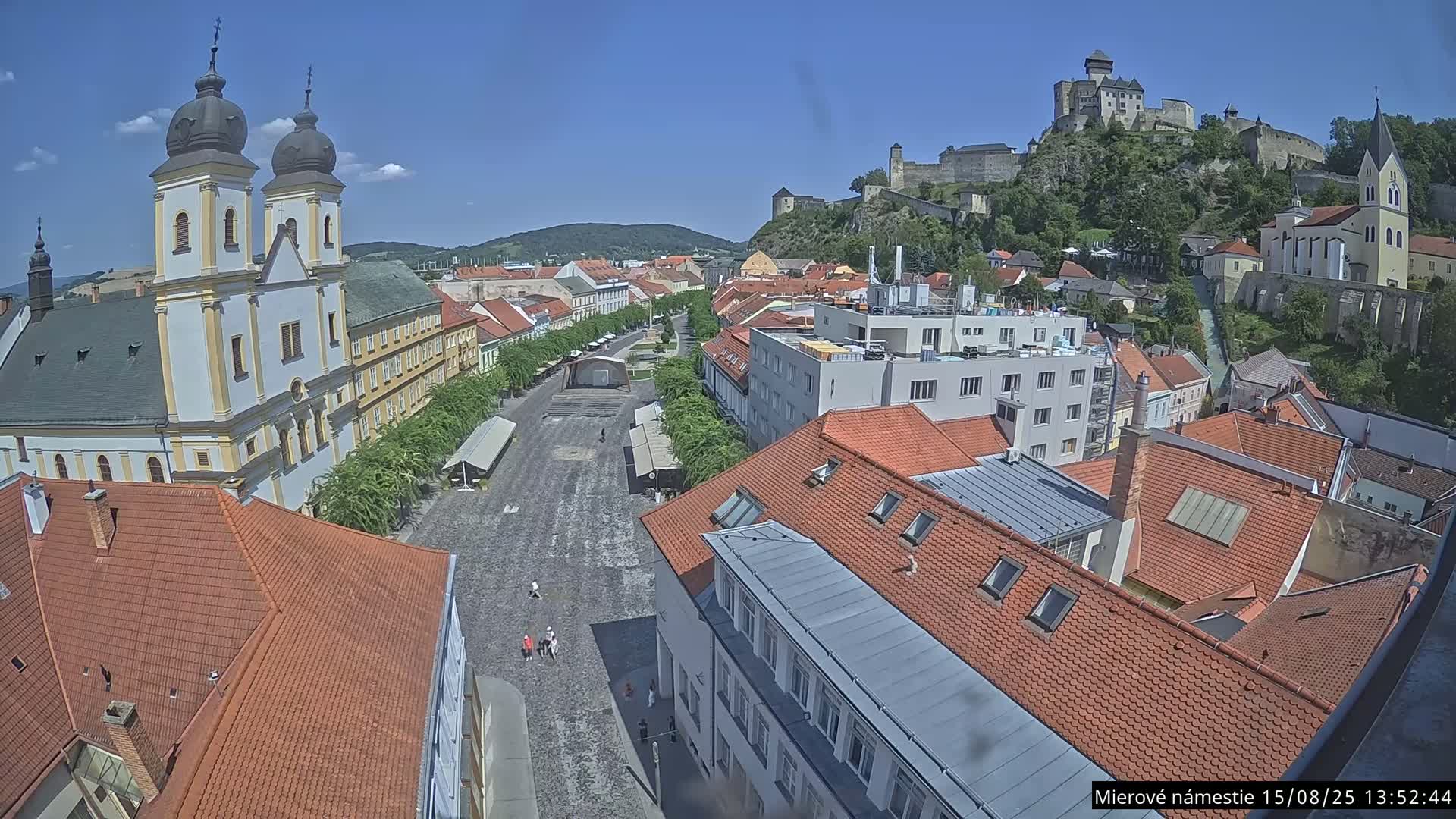 Trenčín, Piaristický kostol sv. Františka Xaverského Church & Trenciansky Hrad (Ttencin Castle) at Mierové námestie Square East View Live Cam - Trencin, Okres Trencin, Slovakia 