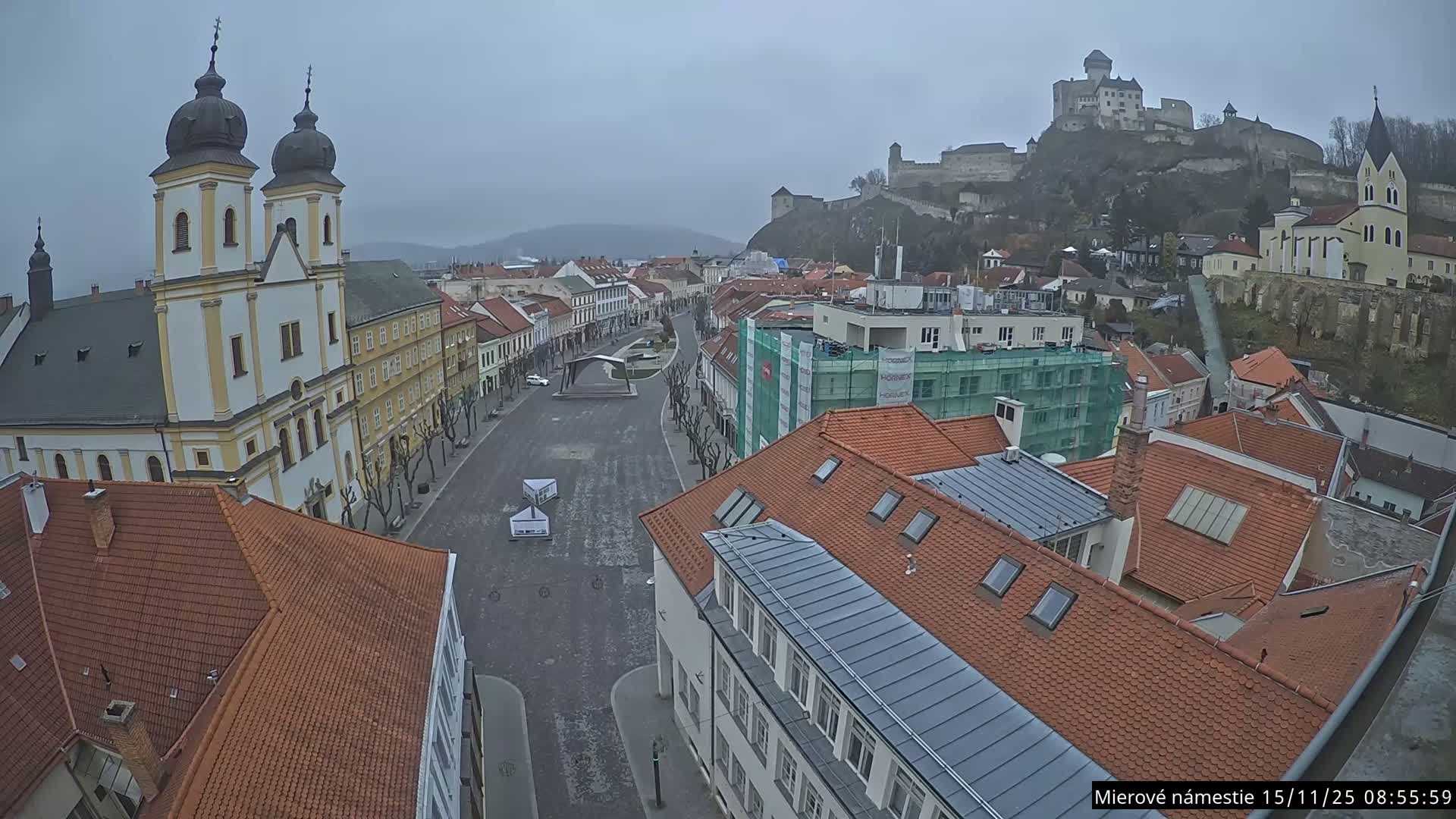 Trenčín, Piaristický kostol sv. Františka Xaverského Church & Trenciansky Hrad (Ttencin Castle) at Mierové námestie Square East View Live Cam - Trencin, Okres Trencin, Slovakia 