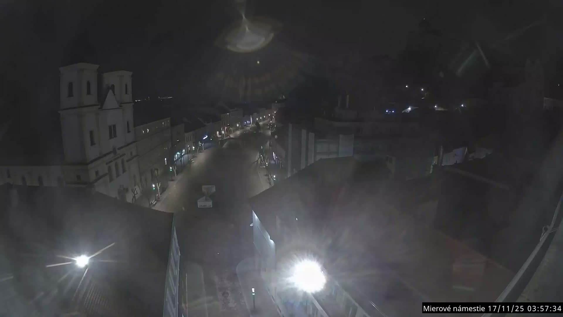 Trenčín, Piaristický kostol sv. Františka Xaverského Church & Trenciansky Hrad (Ttencin Castle) at Mierové námestie Square East View Live Cam - Trencin, Okres Trencin, Slovakia 