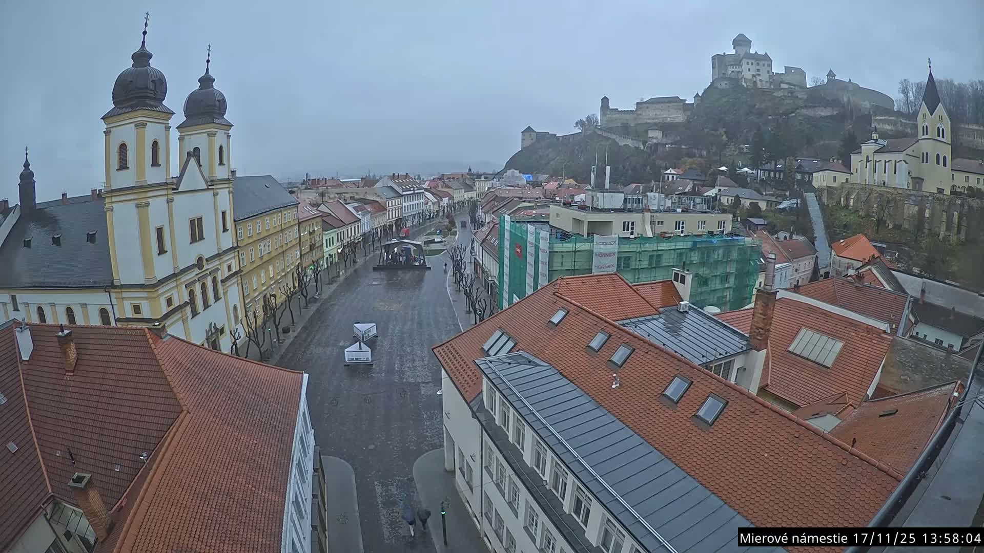 Trenčín, Piaristický kostol sv. Františka Xaverského Church & Trenciansky Hrad (Ttencin Castle) at Mierové námestie Square East View Live Cam - Trencin, Okres Trencin, Slovakia 