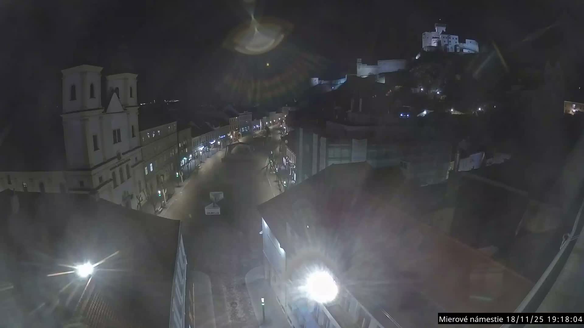 Trenčín, Piaristický kostol sv. Františka Xaverského Church & Trenciansky Hrad (Ttencin Castle) at Mierové námestie Square East View Live Cam - Trencin, Okres Trencin, Slovakia 