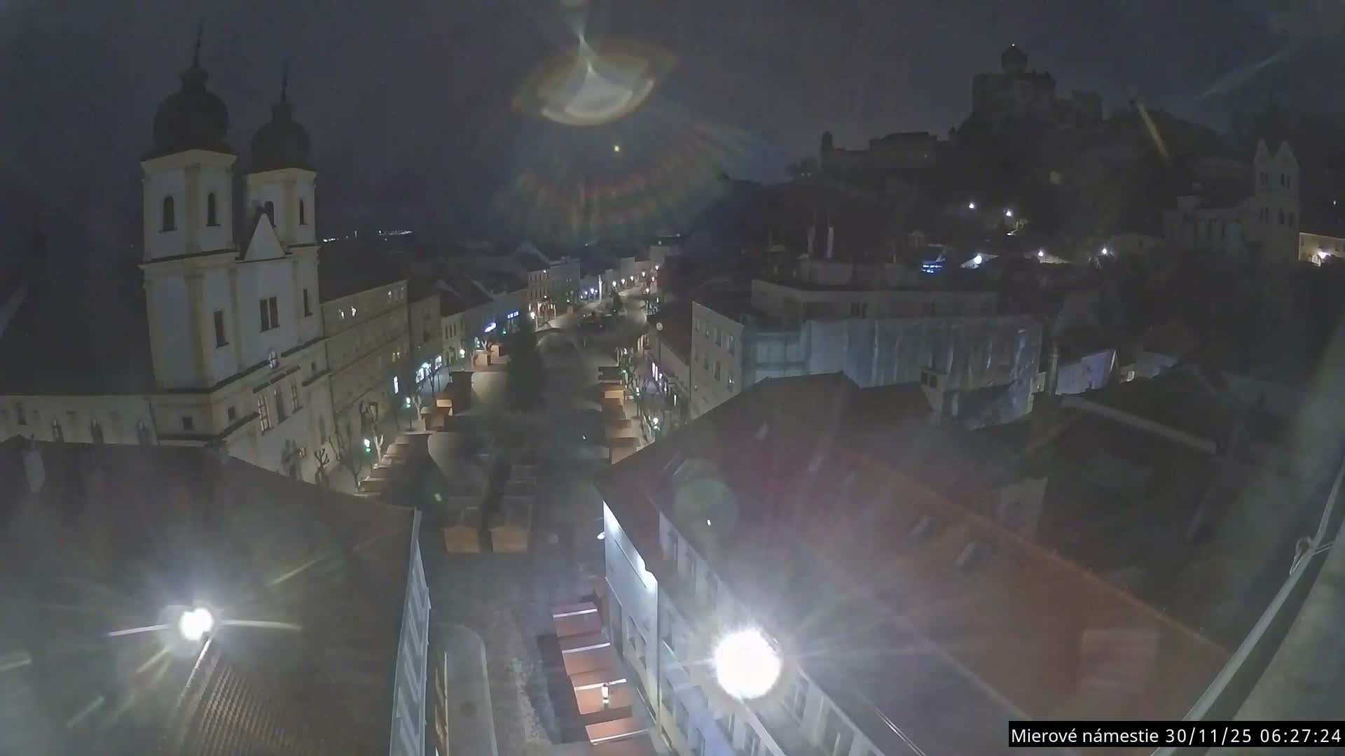 Trenčín, Piaristický kostol sv. Františka Xaverského Church & Trenciansky Hrad (Ttencin Castle) at Mierové námestie Square East View Live Cam - Trencin, Okres Trencin, Slovakia 