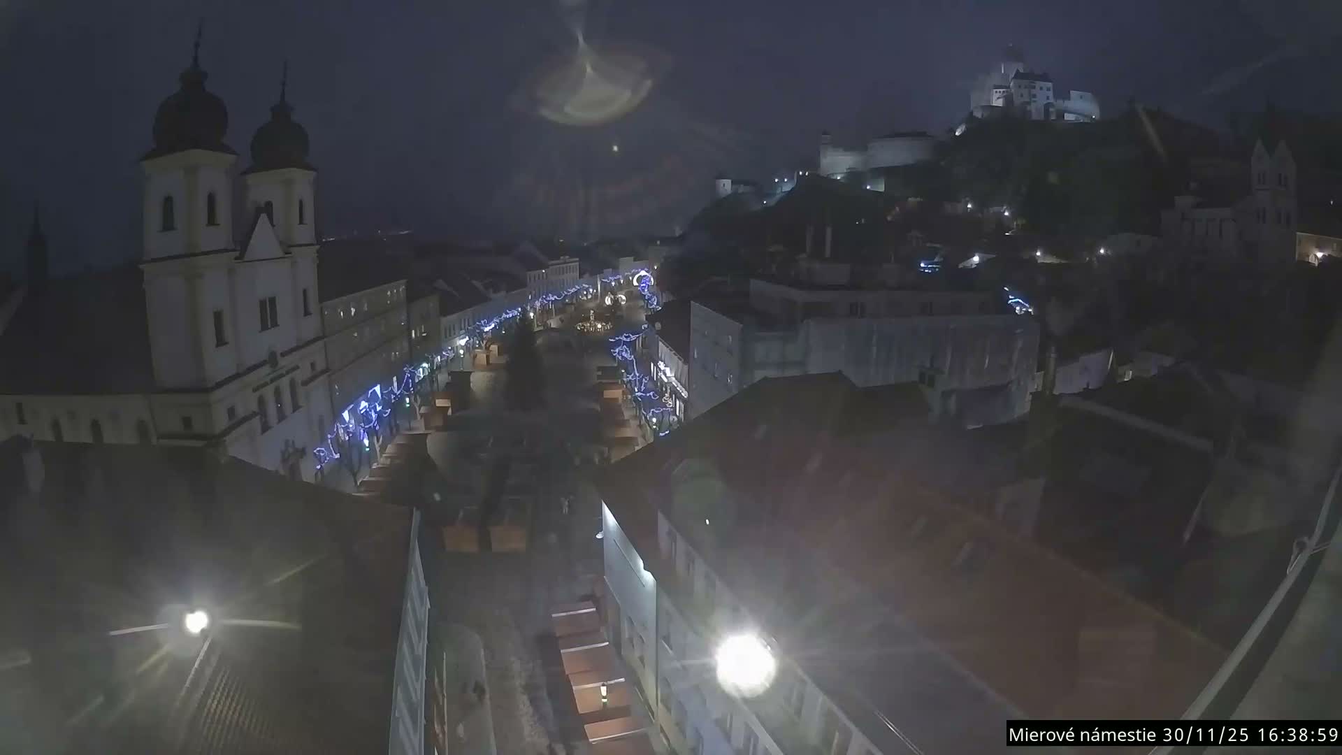 Trenčín, Piaristický kostol sv. Františka Xaverského Church & Trenciansky Hrad (Ttencin Castle) at Mierové námestie Square East View Live Cam - Trencin, Okres Trencin, Slovakia 