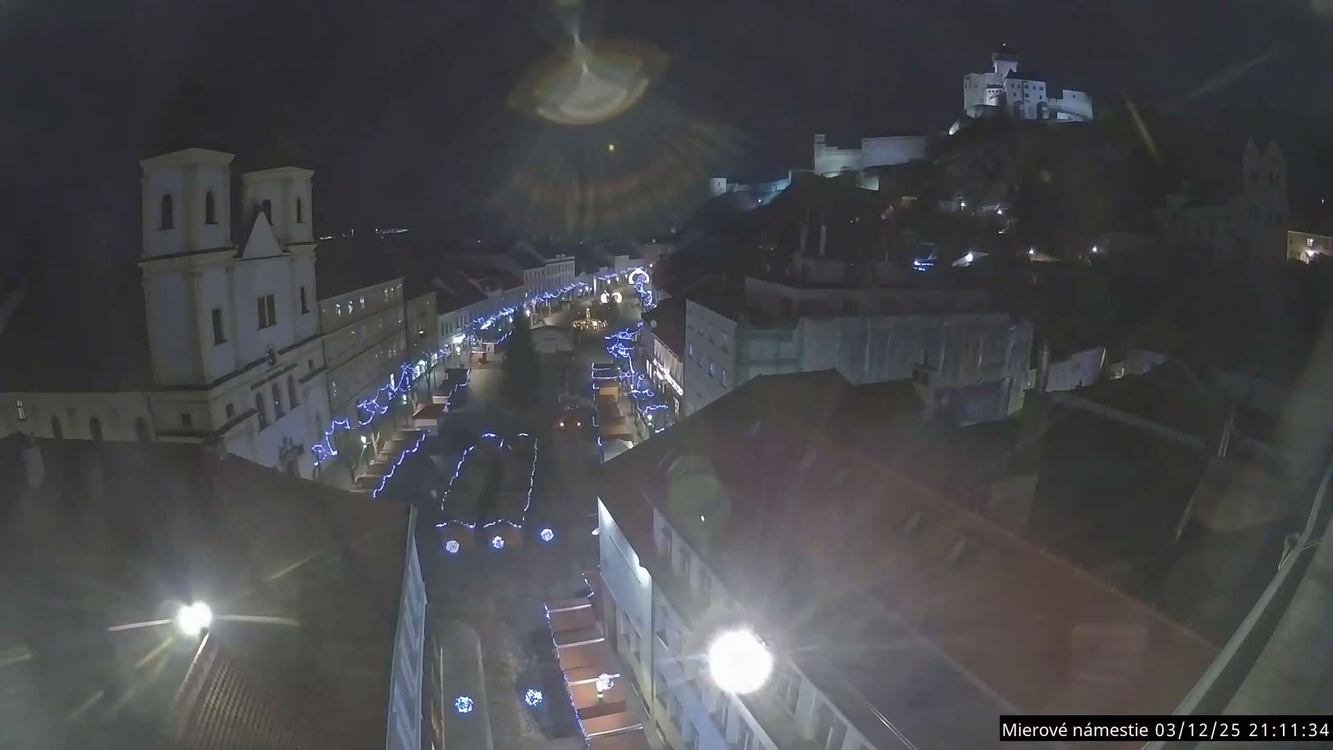 Trenčín, Piaristický kostol sv. Františka Xaverského Church & Trenciansky Hrad (Ttencin Castle) at Mierové námestie Square East View Live Cam - Trencin, Okres Trencin, Slovakia 
