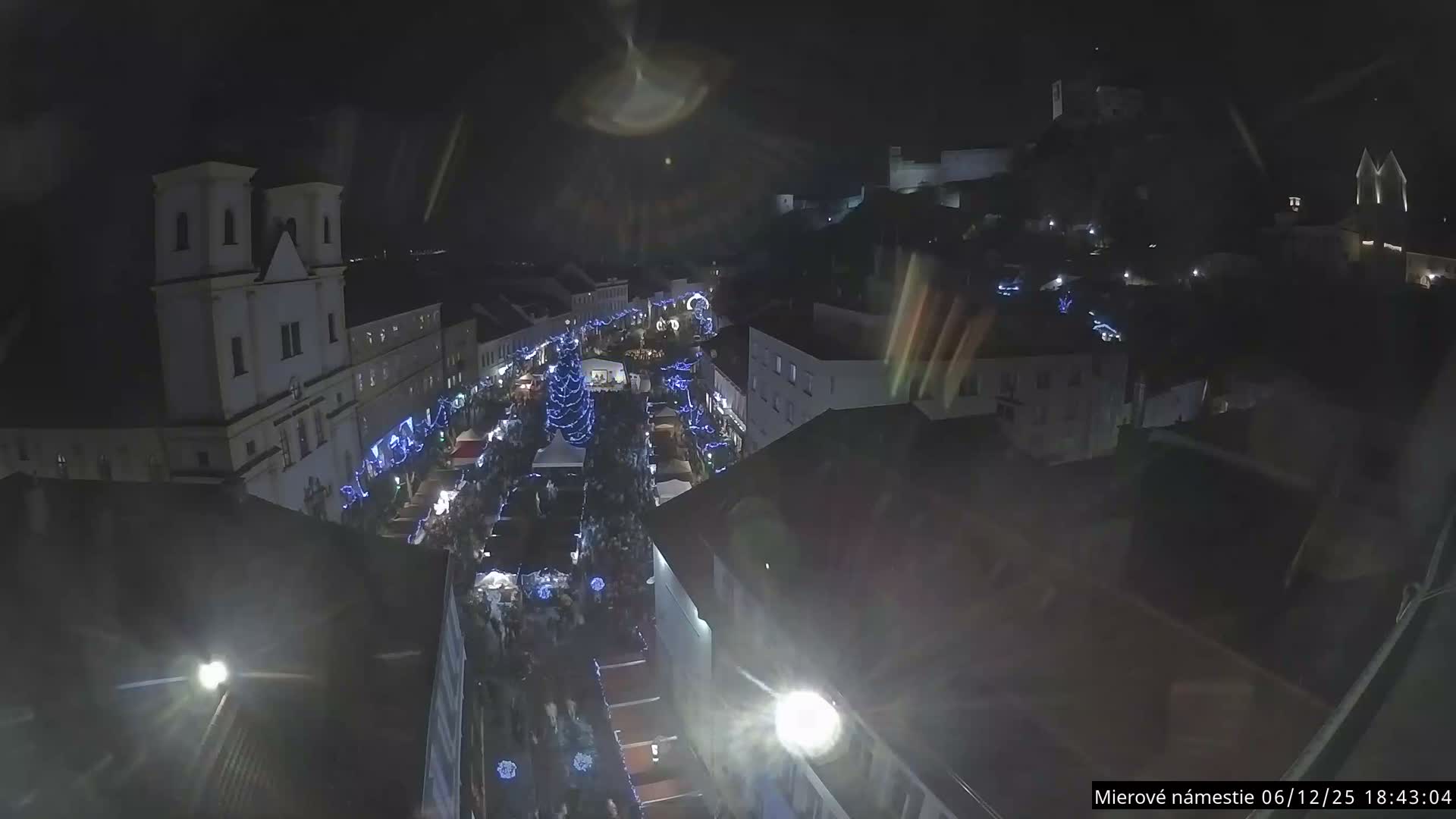 Trenčín, Piaristický kostol sv. Františka Xaverského Church & Trenciansky Hrad (Ttencin Castle) at Mierové námestie Square East View Live Cam - Trencin, Okres Trencin, Slovakia 