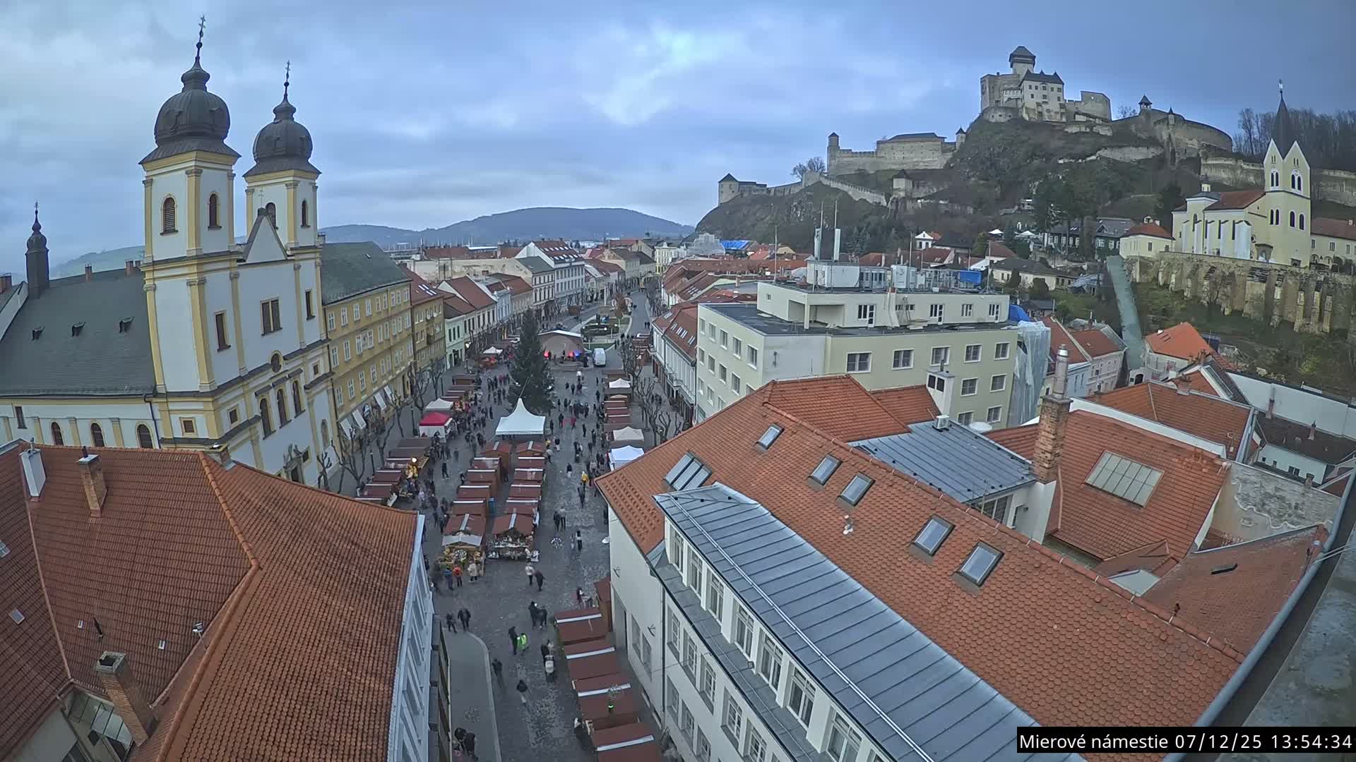 Trenčín, Piaristický kostol sv. Františka Xaverského Church & Trenciansky Hrad (Ttencin Castle) at Mierové námestie Square East View Live Cam - Trencin, Okres Trencin, Slovakia 
