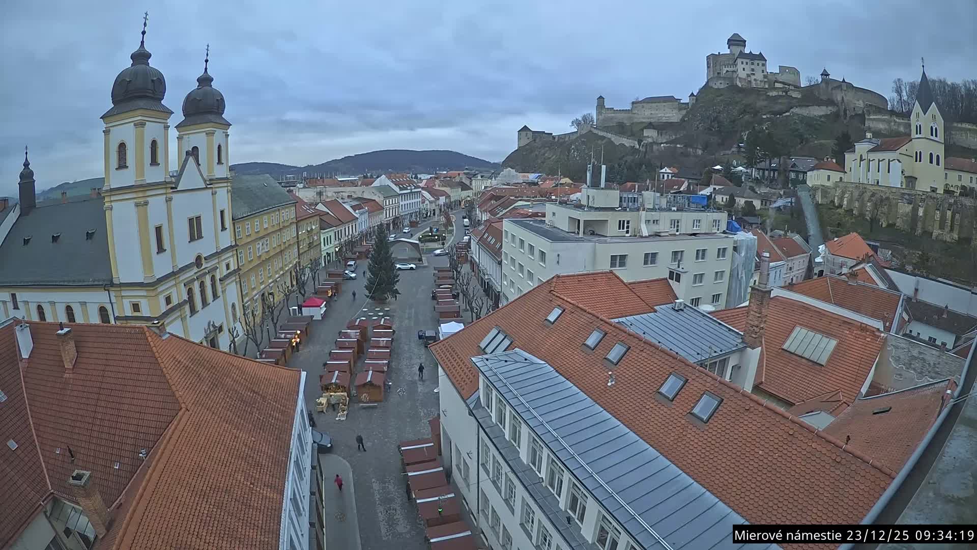 Trenčín, Piaristický kostol sv. Františka Xaverského Church & Trenciansky Hrad (Ttencin Castle) at Mierové námestie Square East View Live Cam - Trencin, Okres Trencin, Slovakia 