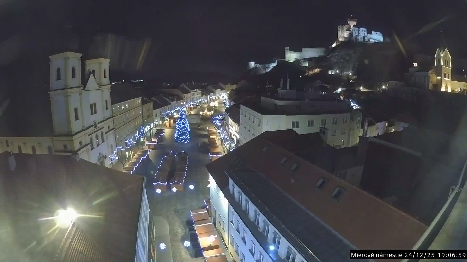 Trenčín, Piaristický kostol sv. Františka Xaverského Church & Trenciansky Hrad (Ttencin Castle) at Mierové námestie Square East View Live Cam - Trencin, Okres Trencin, Slovakia 