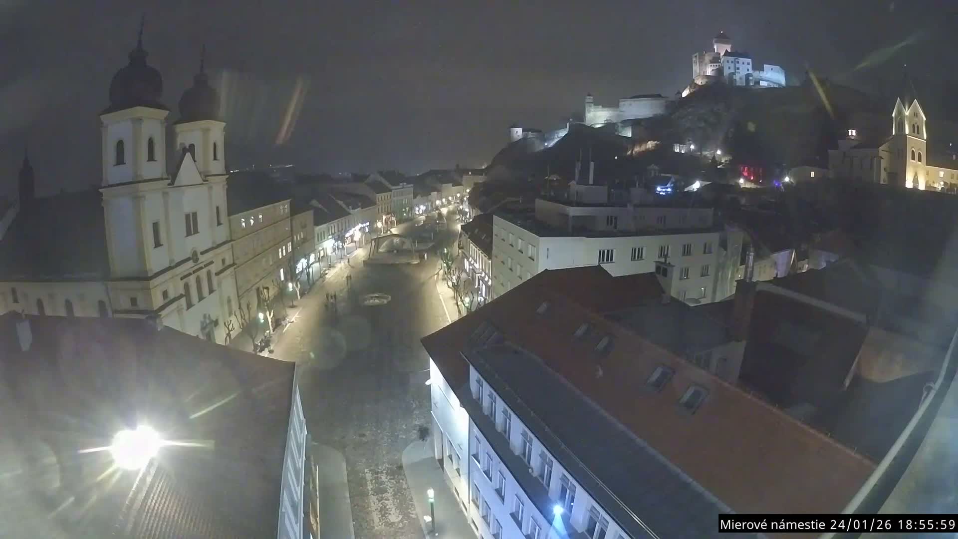 Trenčín, Piaristický kostol sv. Františka Xaverského Church & Trenciansky Hrad (Ttencin Castle) at Mierové námestie Square East View Live Cam - Trencin, Okres Trencin, Slovakia 