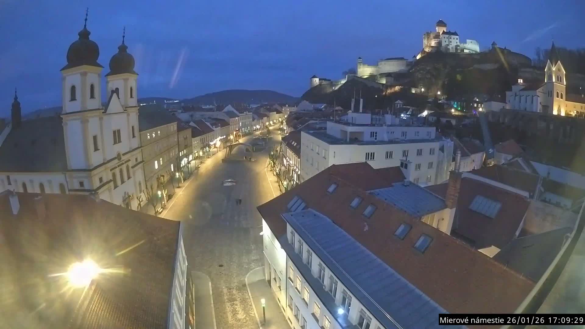 Trenčín, Piaristický kostol sv. Františka Xaverského Church & Trenciansky Hrad (Ttencin Castle) at Mierové námestie Square East View Live Cam - Trencin, Okres Trencin, Slovakia 