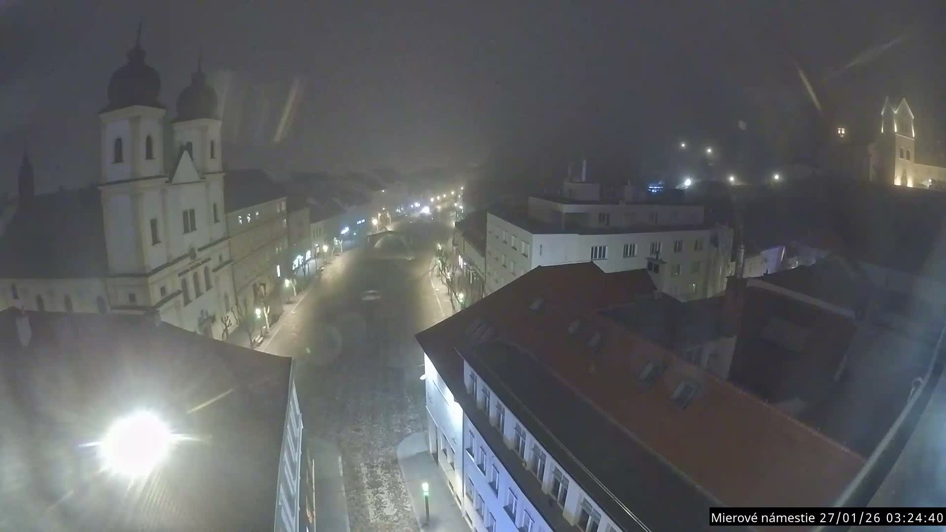 Trenčín, Piaristický kostol sv. Františka Xaverského Church & Trenciansky Hrad (Ttencin Castle) at Mierové námestie Square East View Live Cam - Trencin, Okres Trencin, Slovakia 