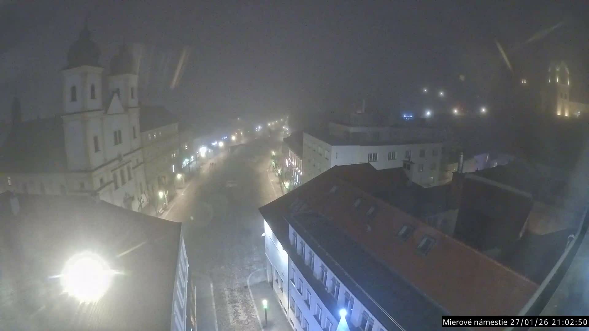 Trenčín, Piaristický kostol sv. Františka Xaverského Church & Trenciansky Hrad (Ttencin Castle) at Mierové námestie Square East View Live Cam - Trencin, Okres Trencin, Slovakia 