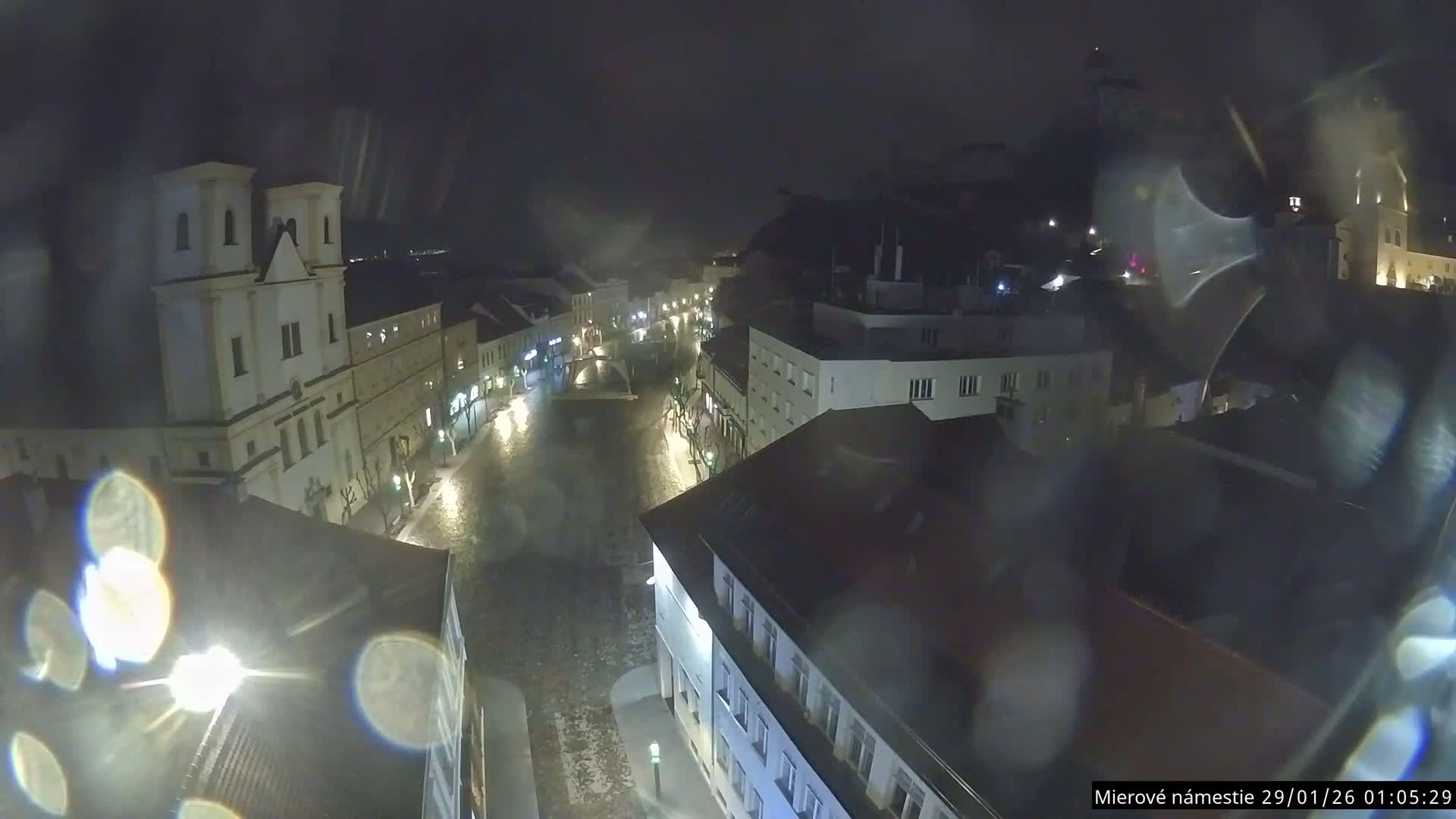 Trenčín, Piaristický kostol sv. Františka Xaverského Church & Trenciansky Hrad (Ttencin Castle) at Mierové námestie Square East View Live Cam - Trencin, Okres Trencin, Slovakia 