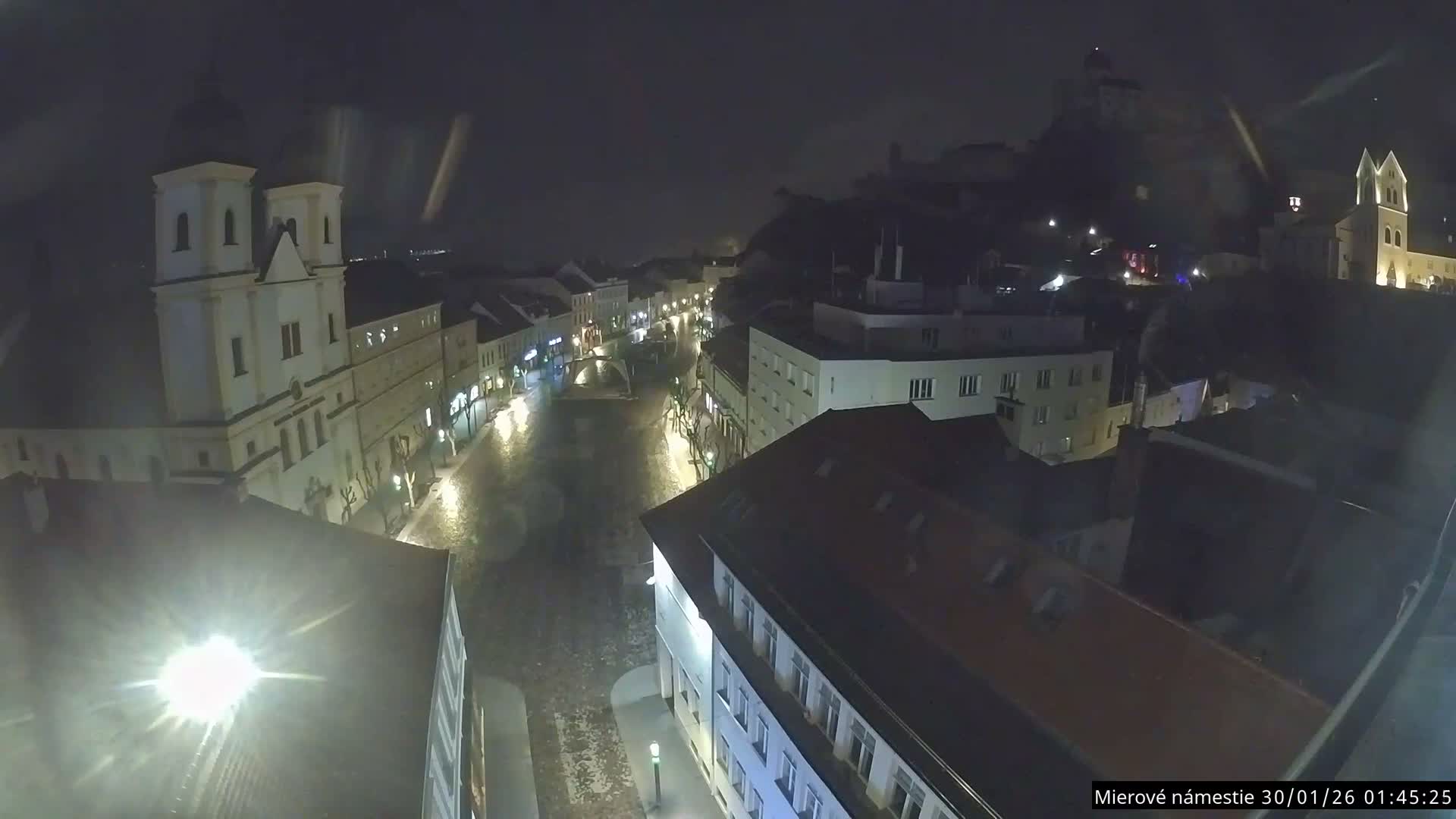 Trenčín, Piaristický kostol sv. Františka Xaverského Church & Trenciansky Hrad (Ttencin Castle) at Mierové námestie Square East View Live Cam - Trencin, Okres Trencin, Slovakia 