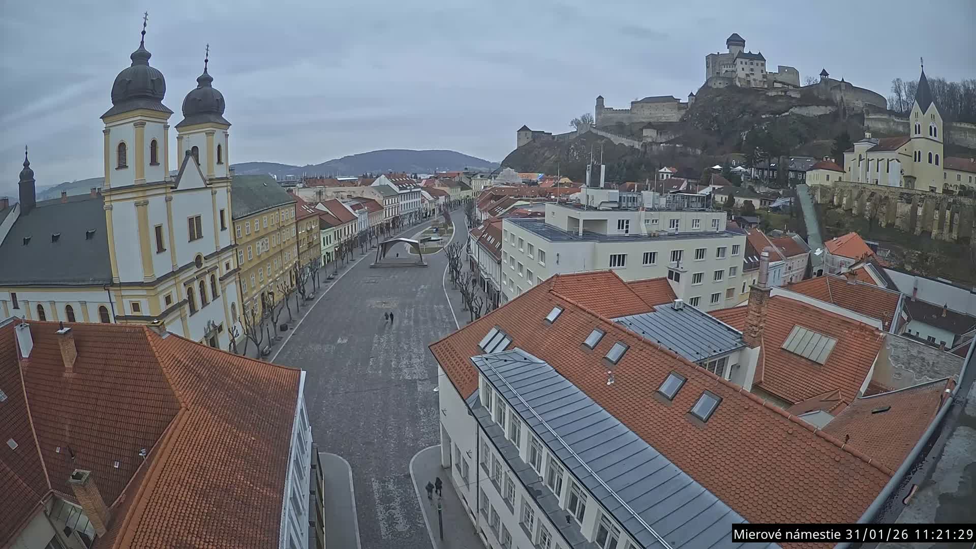 Trenčín, Piaristický kostol sv. Františka Xaverského Church & Trenciansky Hrad (Ttencin Castle) at Mierové námestie Square East View Live Cam - Trencin, Okres Trencin, Slovakia 