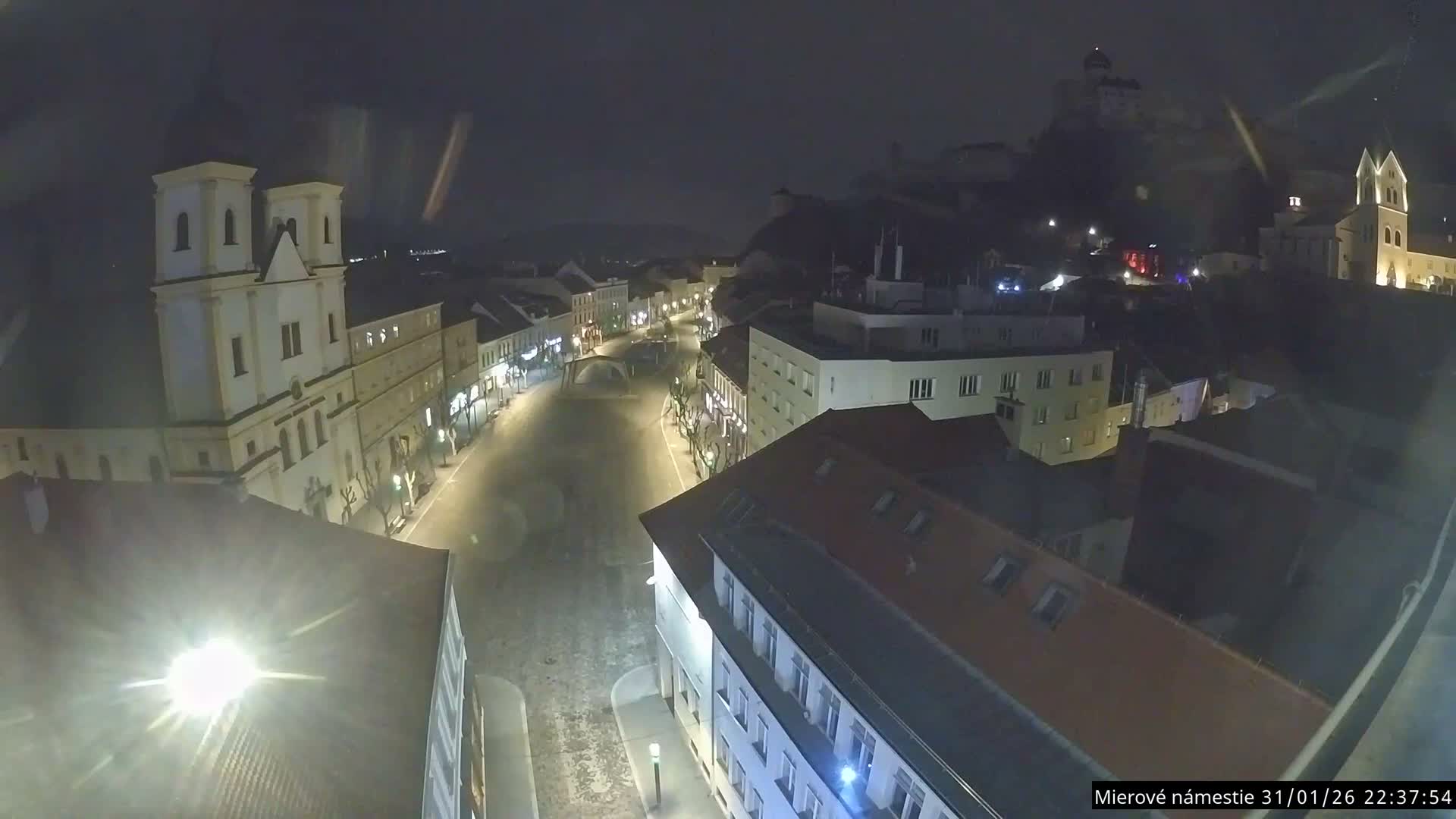 Trenčín, Piaristický kostol sv. Františka Xaverského Church & Trenciansky Hrad (Ttencin Castle) at Mierové námestie Square East View Live Cam - Trencin, Okres Trencin, Slovakia 