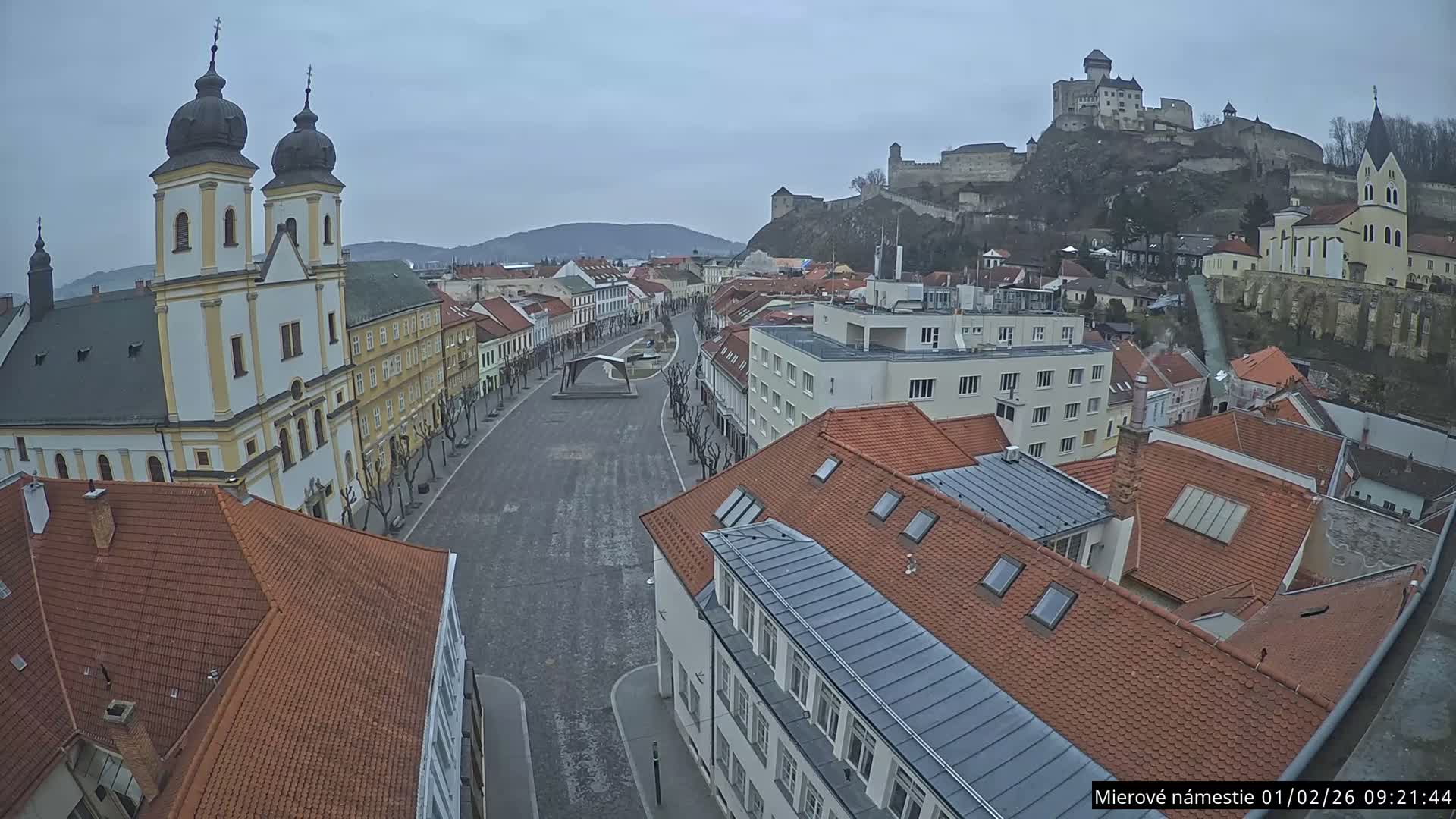 Trenčín, Piaristický kostol sv. Františka Xaverského Church & Trenciansky Hrad (Ttencin Castle) at Mierové námestie Square East View Live Cam - Trencin, Okres Trencin, Slovakia 