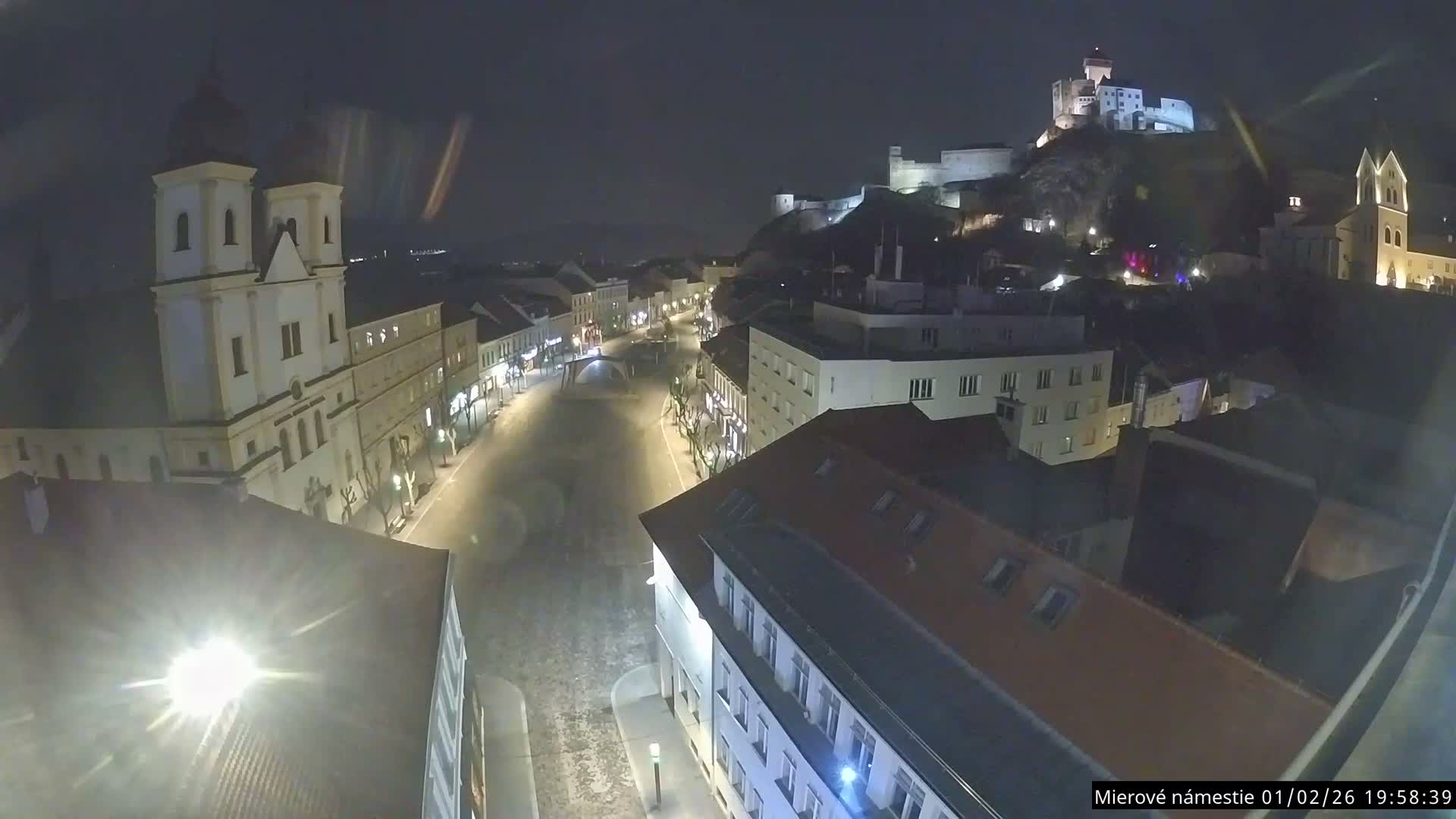 Trenčín, Piaristický kostol sv. Františka Xaverského Church & Trenciansky Hrad (Ttencin Castle) at Mierové námestie Square East View Live Cam - Trencin, Okres Trencin, Slovakia 