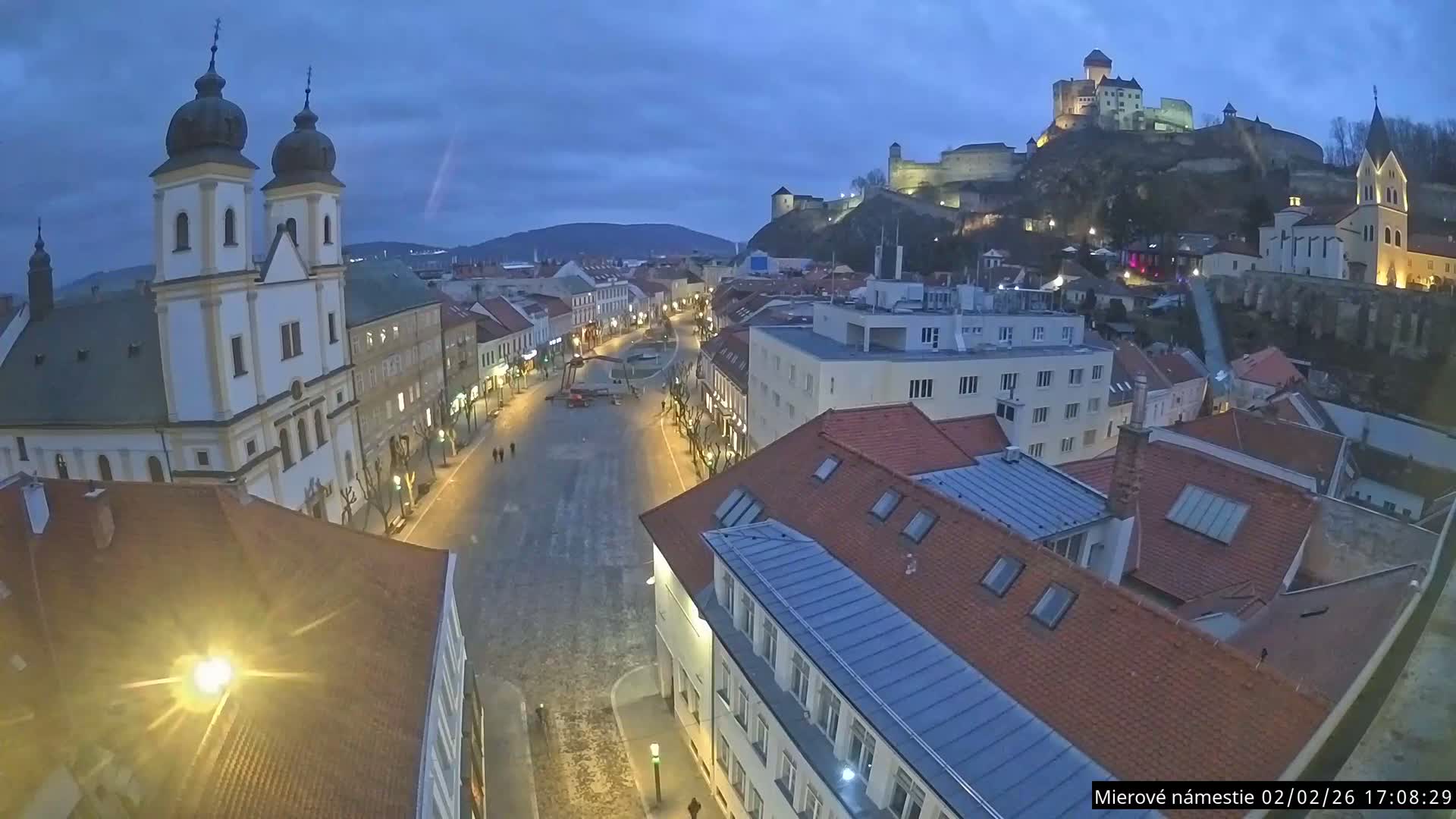 Trenčín, Piaristický kostol sv. Františka Xaverského Church & Trenciansky Hrad (Ttencin Castle) at Mierové námestie Square East View Live Cam - Trencin, Okres Trencin, Slovakia 