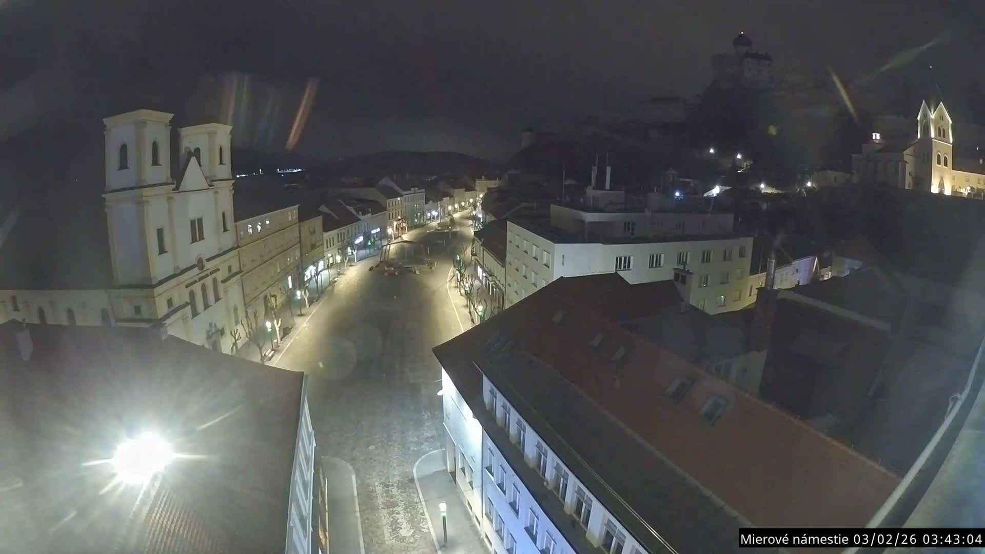 Trenčín, Piaristický kostol sv. Františka Xaverského Church & Trenciansky Hrad (Ttencin Castle) at Mierové námestie Square East View Live Cam - Trencin, Okres Trencin, Slovakia 