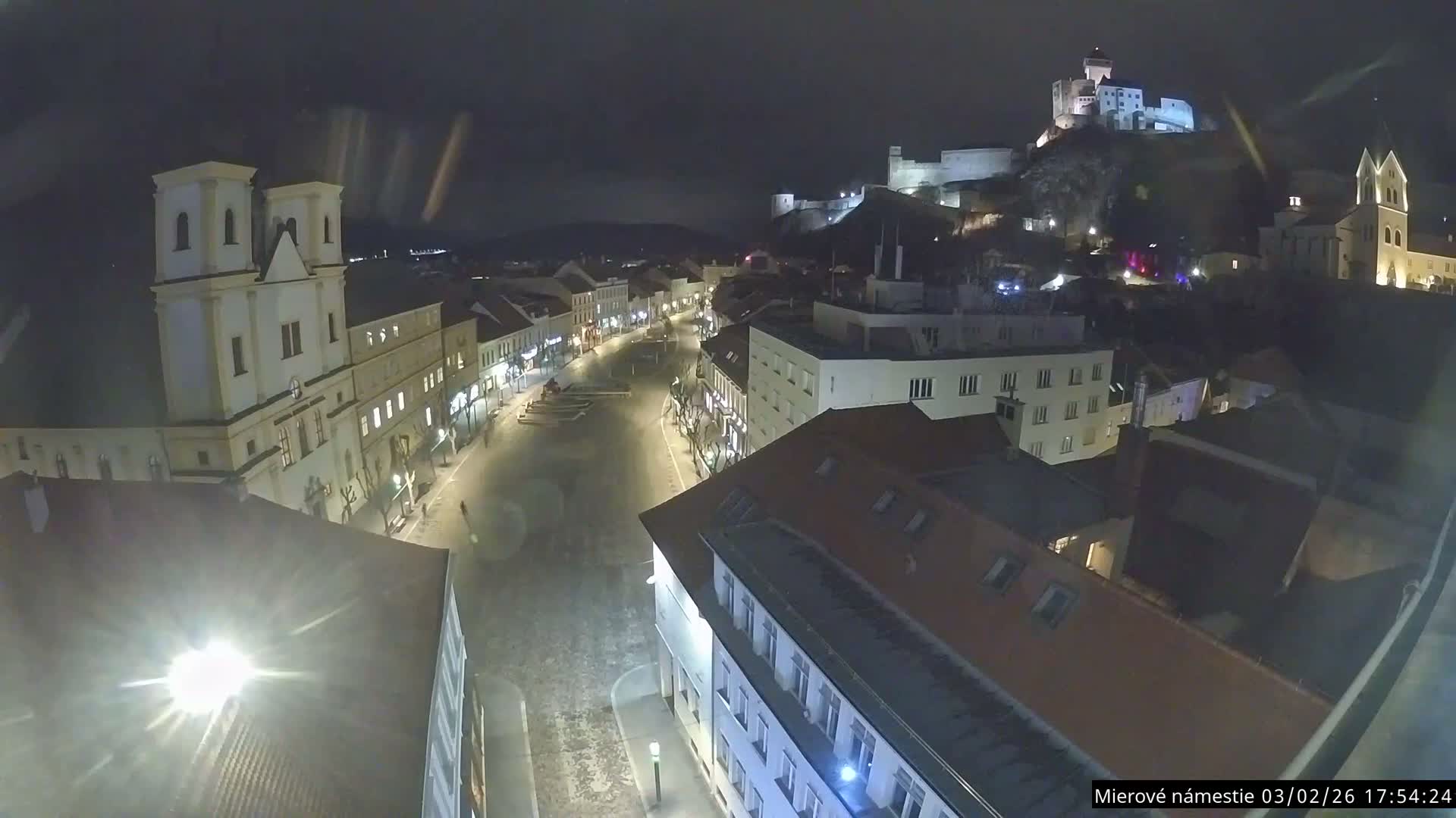 Trenčín, Piaristický kostol sv. Františka Xaverského Church & Trenciansky Hrad (Ttencin Castle) at Mierové námestie Square East View Live Cam - Trencin, Okres Trencin, Slovakia 
