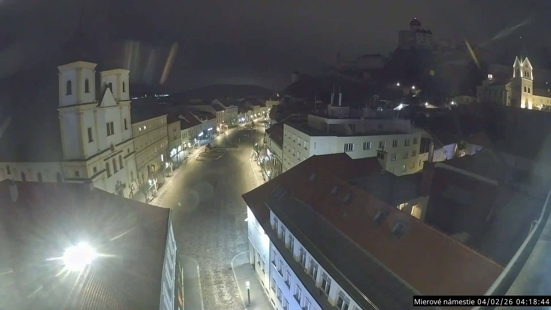 Trenčín, Piaristický kostol sv. Františka Xaverského Church & Trenciansky Hrad (Ttencin Castle) at Mierové námestie Square East View Live Cam - Trencin, Okres Trencin, Slovakia 