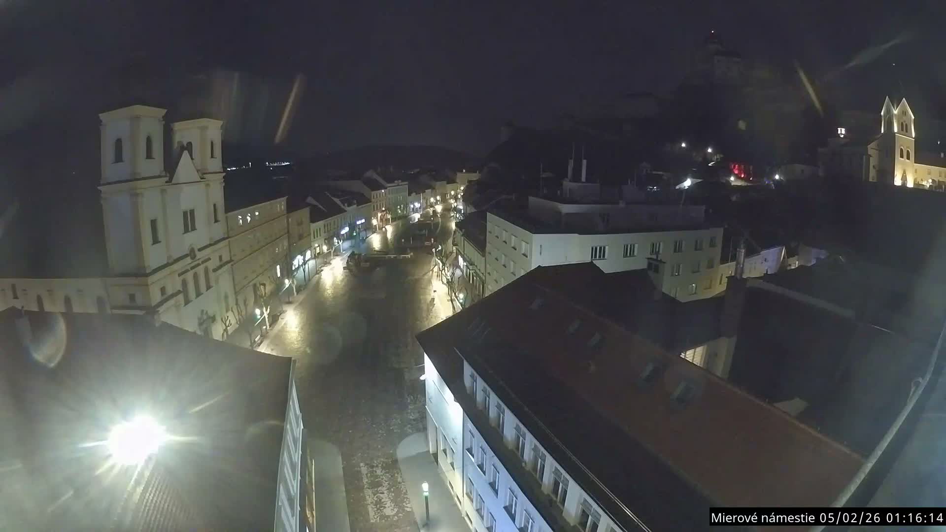 Trenčín, Piaristický kostol sv. Františka Xaverského Church & Trenciansky Hrad (Ttencin Castle) at Mierové námestie Square East View Live Cam - Trencin, Okres Trencin, Slovakia 