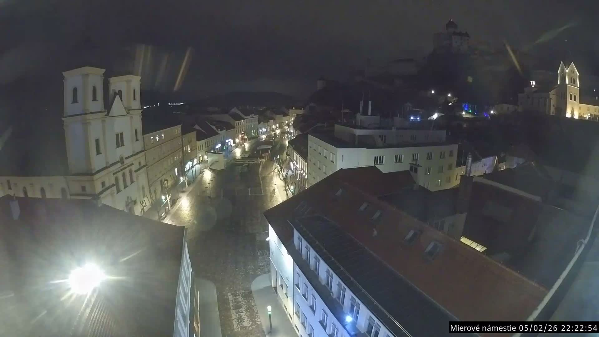 Trenčín, Piaristický kostol sv. Františka Xaverského Church & Trenciansky Hrad (Ttencin Castle) at Mierové námestie Square East View Live Cam - Trencin, Okres Trencin, Slovakia 