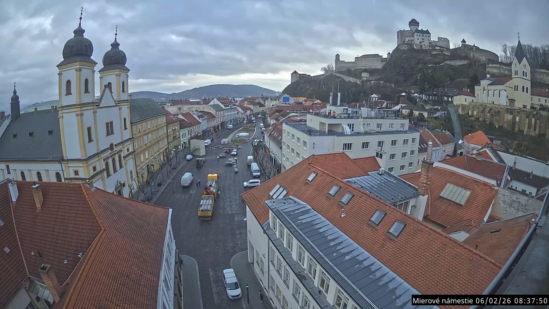 Trenčín, Piaristický kostol sv. Františka Xaverského Church & Trenciansky Hrad (Ttencin Castle) at Mierové námestie Square East View Live Cam - Trencin, Okres Trencin, Slovakia 