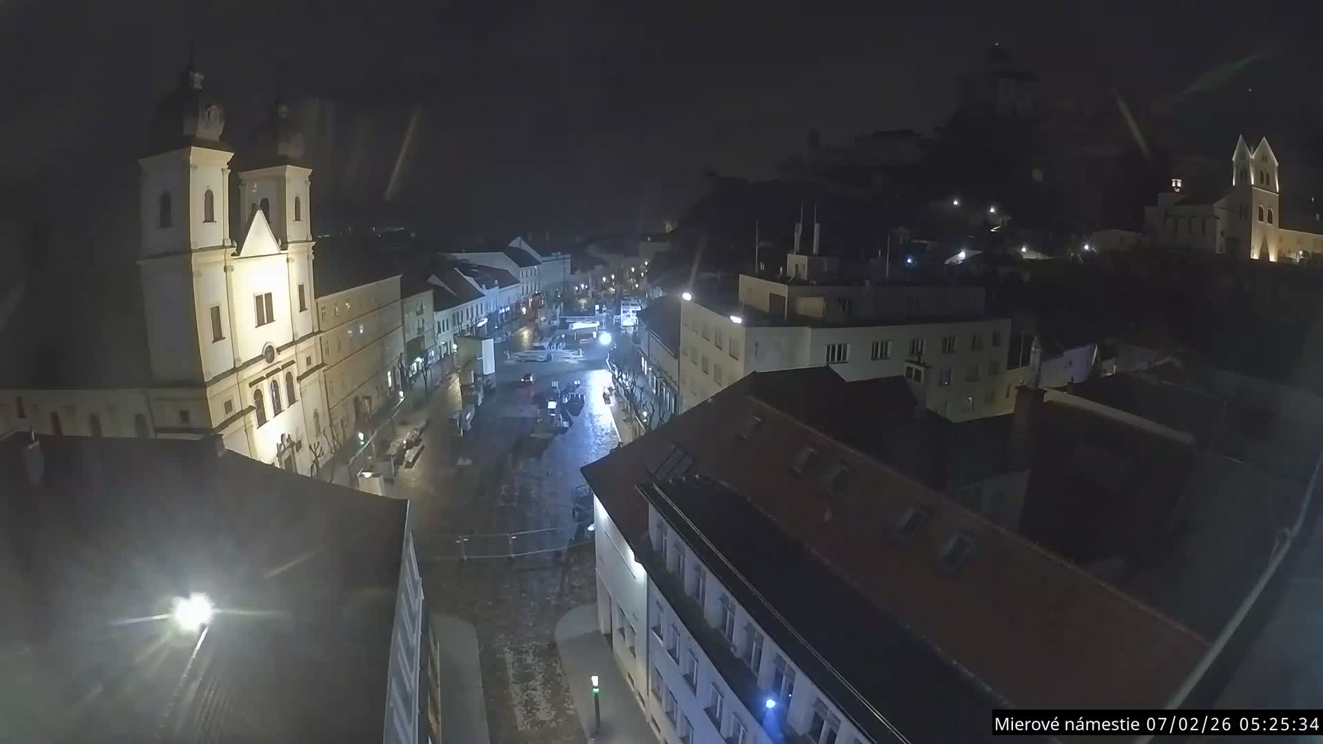 Trenčín, Piaristický kostol sv. Františka Xaverského Church & Trenciansky Hrad (Ttencin Castle) at Mierové námestie Square East View Live Cam - Trencin, Okres Trencin, Slovakia 