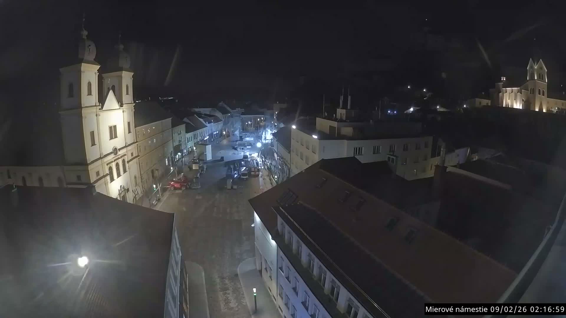 Trenčín, Piaristický kostol sv. Františka Xaverského Church & Trenciansky Hrad (Ttencin Castle) at Mierové námestie Square East View Live Cam - Trencin, Okres Trencin, Slovakia 