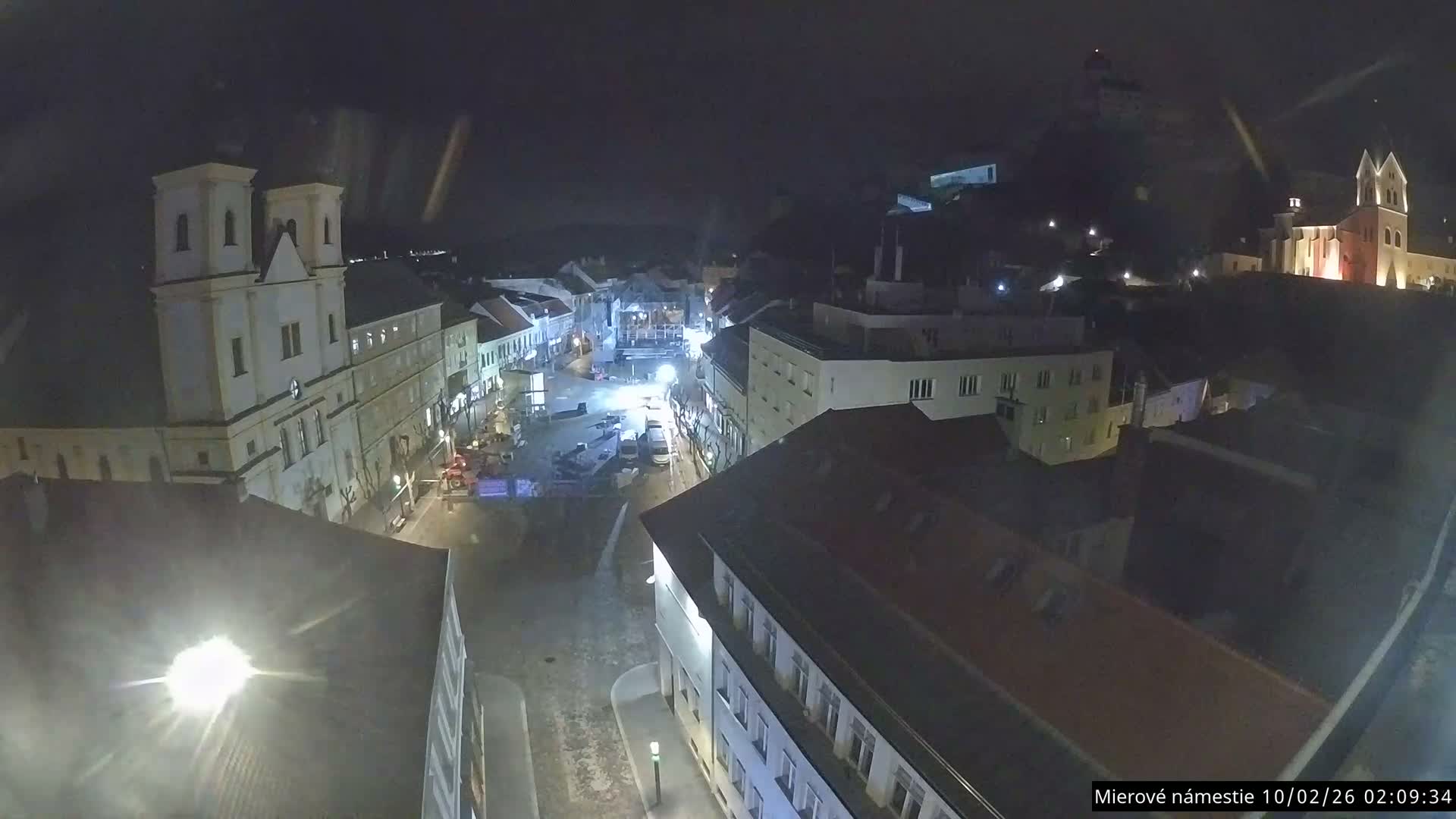 Trenčín, Piaristický kostol sv. Františka Xaverského Church & Trenciansky Hrad (Ttencin Castle) at Mierové námestie Square East View Live Cam - Trencin, Okres Trencin, Slovakia 