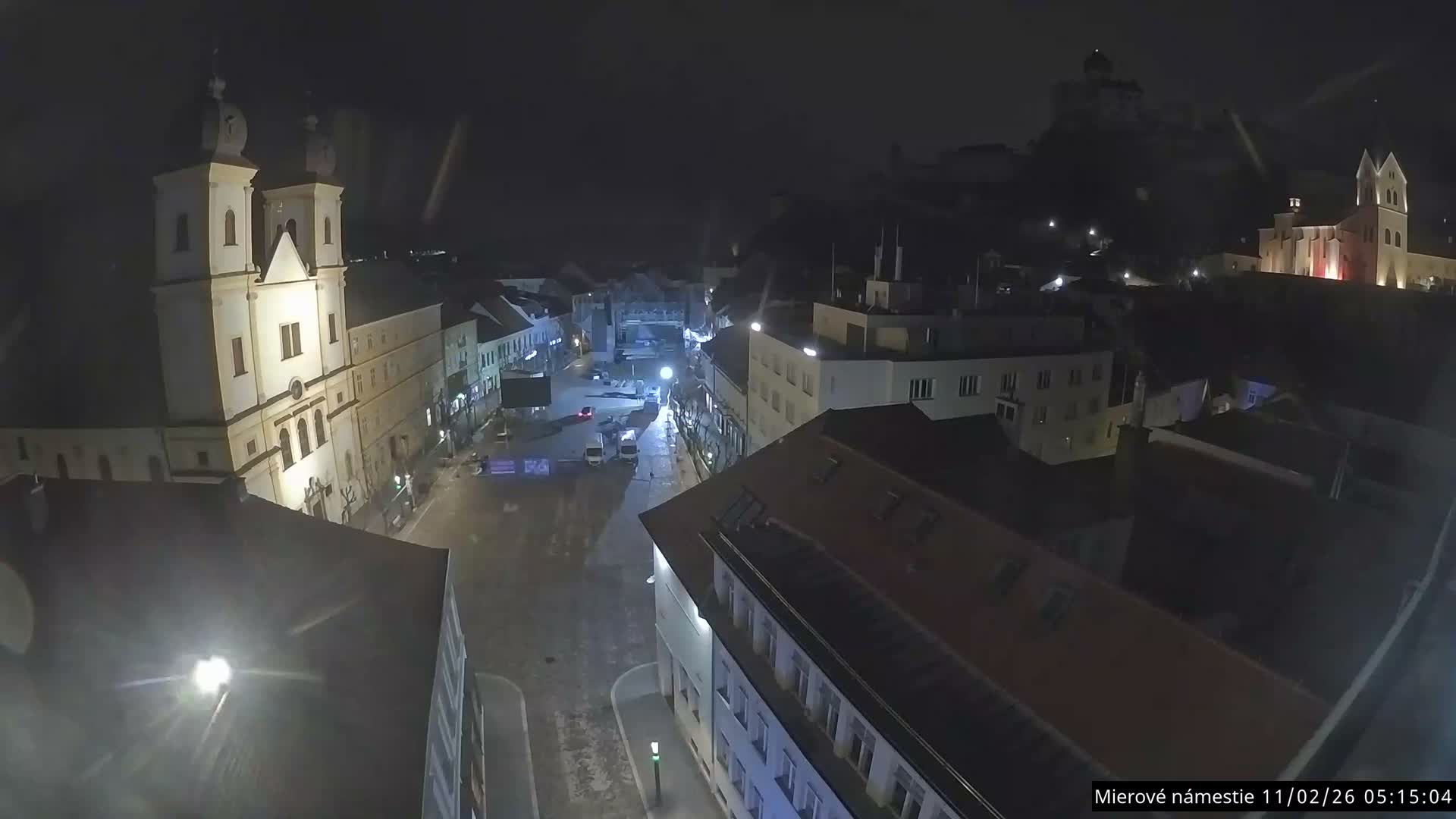 Trenčín, Piaristický kostol sv. Františka Xaverského Church & Trenciansky Hrad (Ttencin Castle) at Mierové námestie Square East View Live Cam - Trencin, Okres Trencin, Slovakia 