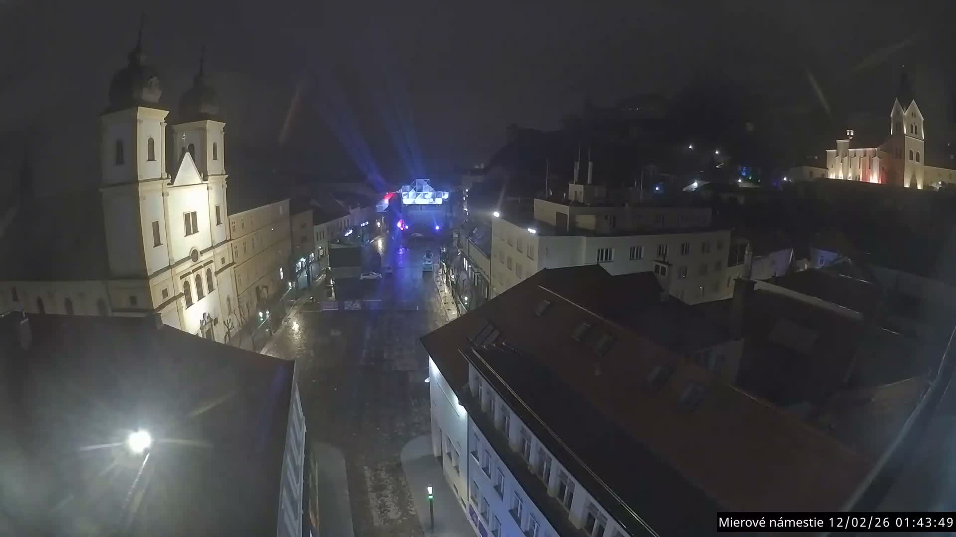 Trenčín, Piaristický kostol sv. Františka Xaverského Church & Trenciansky Hrad (Ttencin Castle) at Mierové námestie Square East View Live Cam - Trencin, Okres Trencin, Slovakia 