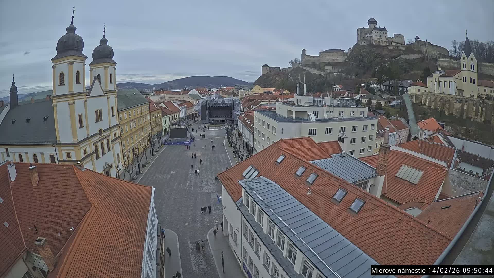 Trenčín, Piaristický kostol sv. Františka Xaverského Church & Trenciansky Hrad (Ttencin Castle) at Mierové námestie Square East View Live Cam - Trencin, Okres Trencin, Slovakia 