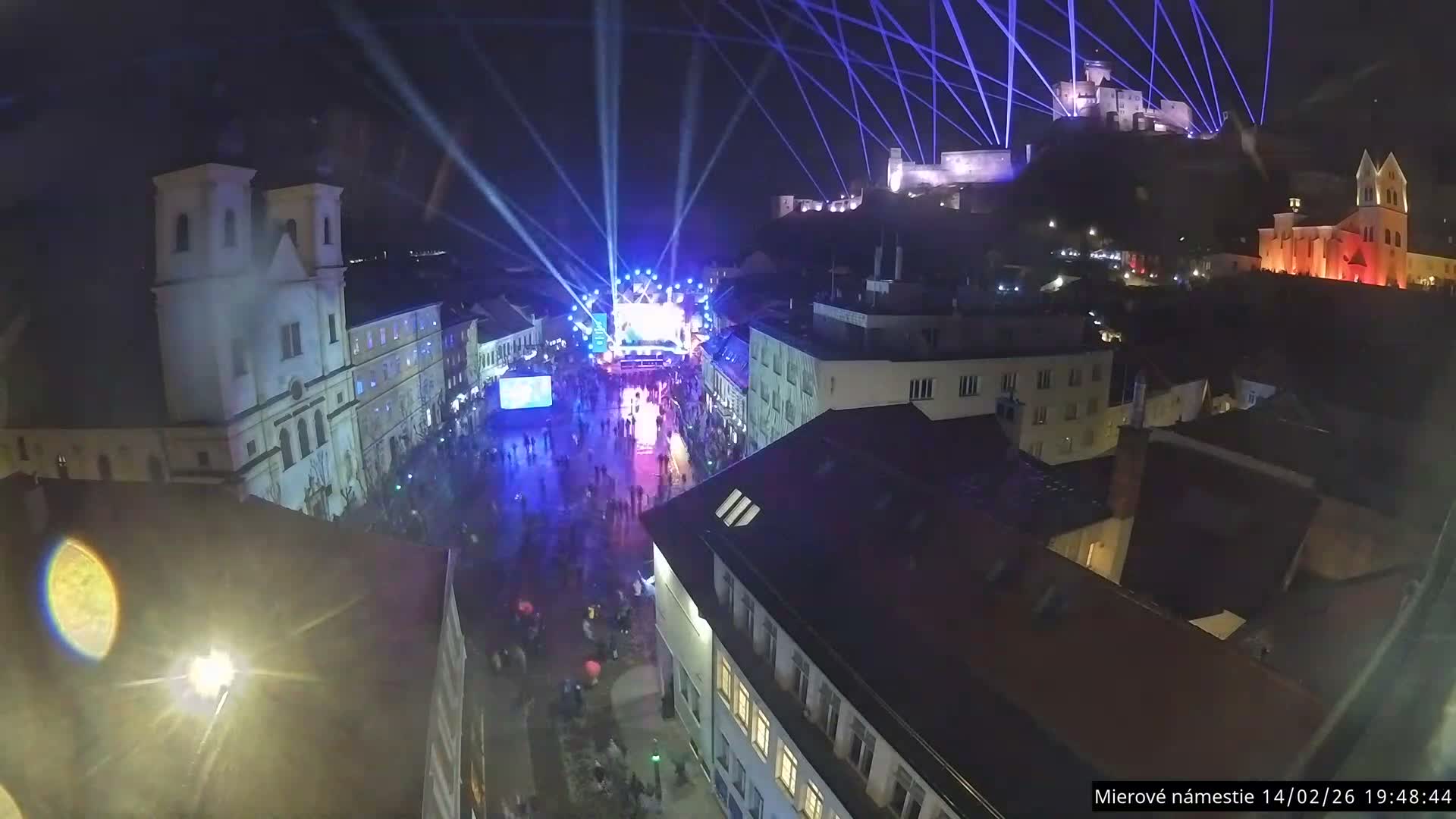 Trenčín, Piaristický kostol sv. Františka Xaverského Church & Trenciansky Hrad (Ttencin Castle) at Mierové námestie Square East View Live Cam - Trencin, Okres Trencin, Slovakia 