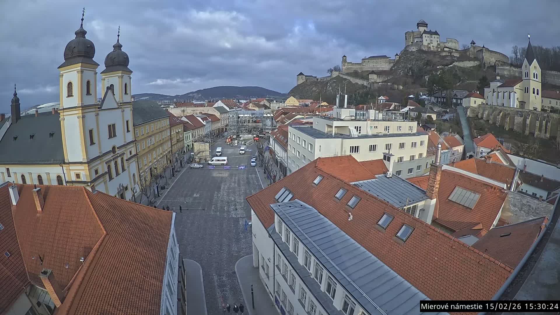 Trenčín, Piaristický kostol sv. Františka Xaverského Church & Trenciansky Hrad (Ttencin Castle) at Mierové námestie Square East View Live Cam - Trencin, Okres Trencin, Slovakia 